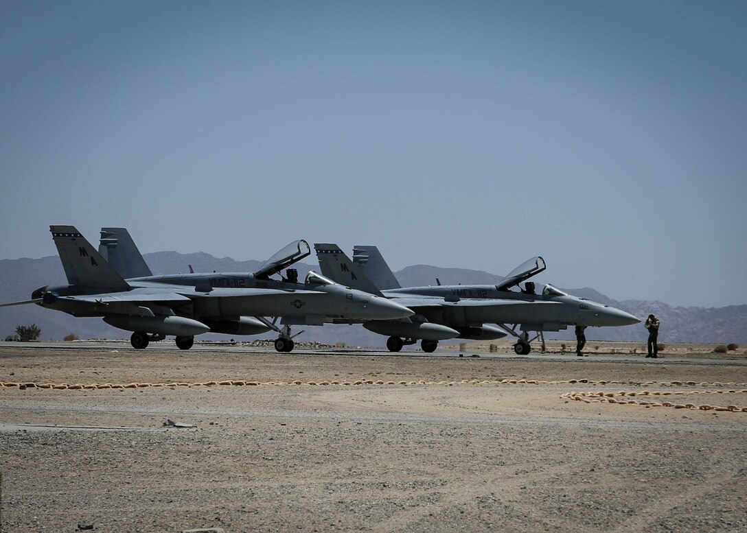 Two F/A-18 Hornet Marine aircraft park aside a Strategic Expeditionary Landing Field during Integrated Training Exercise 4-14 aboard Camp Wilson, Twentynine Palms, California, June 7, 2014. ITX 4-14, a cornerstone of the Marine Air-Ground Task Force Training Program, is the largest annual U.S. Marine Corps Reserve training exercise that helps sharpen skills and planning guidance for Reserve units. ITX employs assets from ground, air and logistics combat elements to demonstrate the ability to deploy rapidly and build up significant combat power necessary to form a MAGTF. (U.S. Marine Corps photo by Cpl. Lauren Whitney/RELEASED)