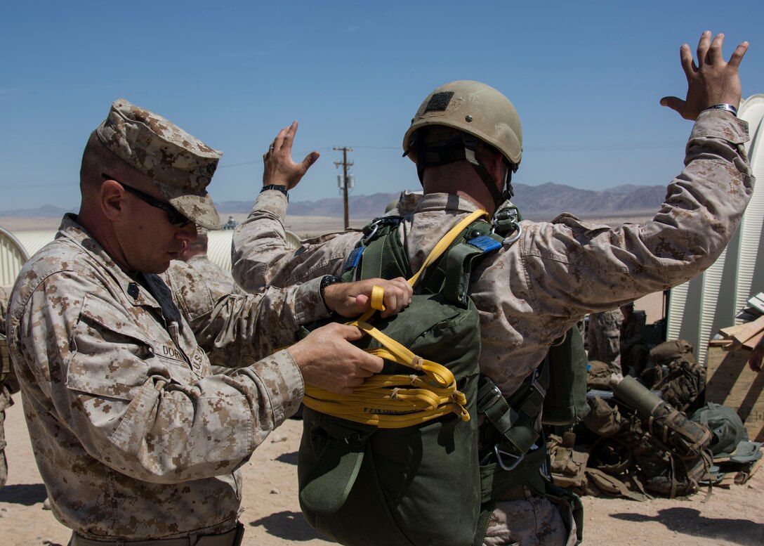 U.S. Marine Master Sgt. Mark Dornak, jump master with Charlie Company, 4th Reconnaissance Battalion, checks a Marines gear before conducting a low level static line jump exercise during Integrated Training Exercise (ITX) 4-14 aboard Marine Corps Air-Ground Combat Center, Twentynine Palms, California, June 8, 2014. ITX 4-14, a cornerstone of the Marine Air-Ground Task Force Training Program, is the largest annual U.S. Marine Corps Reserve training exercise that helps sharpen skills and planning guidance for Reserve units. ITX employs assets from ground, air and logistics combat elements to demonstrate the ability to deploy rapidly and build up significant combat power necessary to form a MAGTF. (U.S. Marine Corps photo by Cpl. Lauren Whitney/RELEASED)