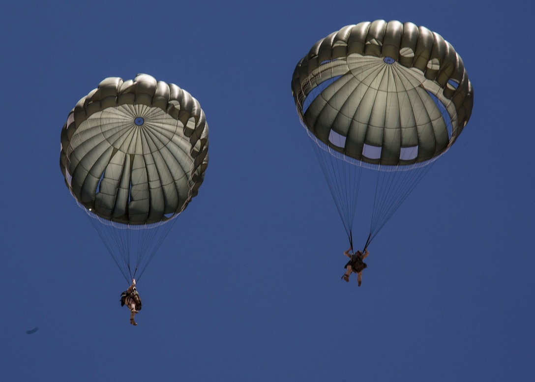 U.S. Marines with Charlie Company, 4th Reconnaissance Battalion, descent torward the drop zone after conducting a low level static line jump out of a CH-46E Sea Knight helicopter during Integrated Training Exercise (ITX) 4-14 aboard Marine Corps Air-Ground Combat Center, Twentynine Palms, California, June 8, 2014. ITX 4-14, a cornerstone of the Marine Air-Ground Task Force Training Program, is the largest annual U.S. Marine Corps Reserve training exercise ITX 4-14 that helps sharpen skills and planning guidance for Reserve units. ITX employs assets from ground, air and logistics combat elements to demonstrate the ability to deploy rapidly and build up significant combat power necessary to form a MAGTF. (U.S. Marine Corps photo by Cpl. Lauren Whitney/RELEASED)
