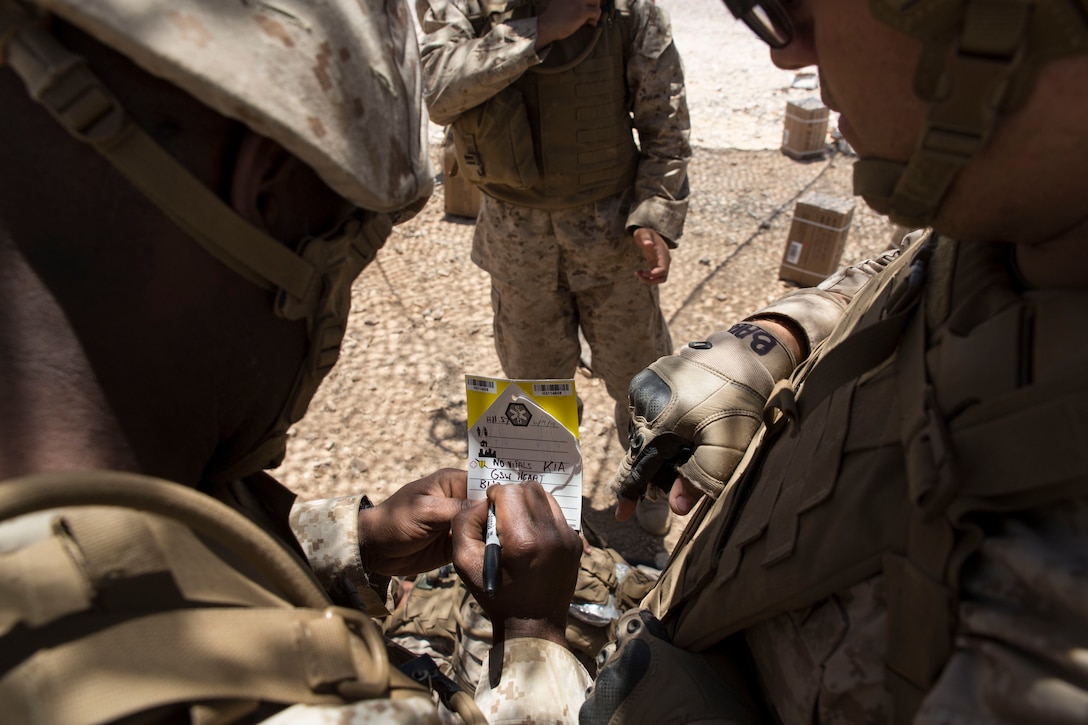 A corpsman with Shock Trauma Platoon, 4th Medical Battalion, Marine Forces Reserve, tags a patient with his vitals druing a realistic casualty scenario as part of Integrated Training Exercise 4-14 here, June 9, 2014. The platoon's objective is to recieve all casualties within Marine Air-Ground Task Force 23 to evaluate their injuries for the Forward Resuscitative Surgical Suite where the decision is made to move the patient to a higher echelon of medical care.