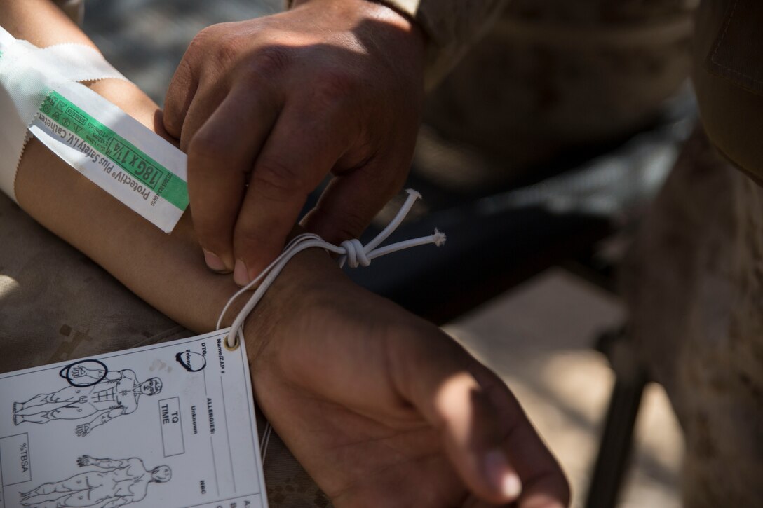 A corpsman with Shock Trauma Platoon, 4th Medical Battalion, Marine Forces Reserve, monitors a patient's vitals during realistic casualty scenarios as part of Integrated Training Exercise 4-14 here, June 9 2014. The platoon's objective is to recieve all casualties within Marine Air-Ground Task Force 23 and evaluate their injuries for the Forward Resuscitative Surgical Suite where the decision is made whether or not to move the patient to a higher echelon of medical care.