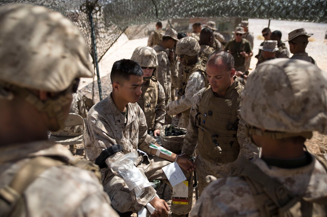 Corpsmen with Shock Trauma Platoon, 4th Medical Battalion, Marine Forces Reserve, monitor a patient's vitals during a realistic casualty scenario as part of Integrated Training Exercise 4-14 here, June 9, 2014. The platoon's objective is to recieve all casualties within Marine Air-Ground Task Force 23 and evaluate their injuries for the Forward Resuscitative Surgical Suite where the decision is made whether or not to move the patient to a higher echelon of medical care.