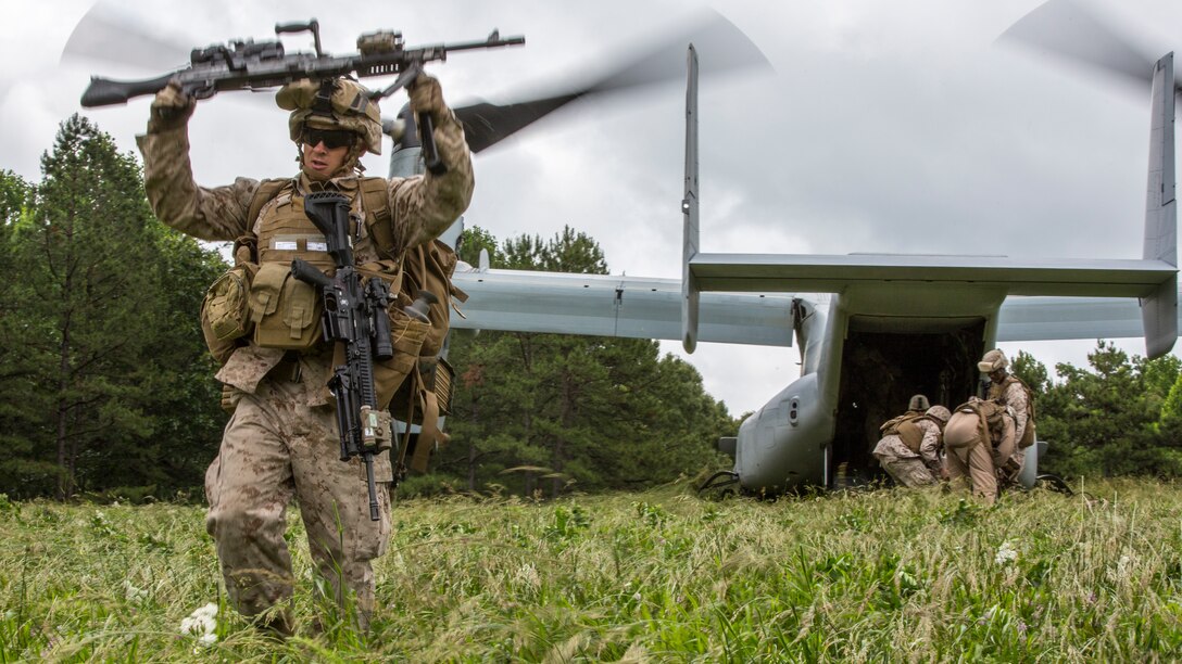 Marines and sailors with Golf Company, 2nd Battalion, 2nd Marine Regiment (2/2), exit an MV-22B Osprey during embassy reinforcment training aboard Quantico, Va., June 12. The 26th Marine Expeditionary Unit, 2/2 and VMM-264 conducted embassy reinforcement training June 10-13, 2014. Marines conducted the training to prepare for possible real world scenarios. (U.S. Marine Corps photo by Lance Cpl. Joshua W. Brown/Released)