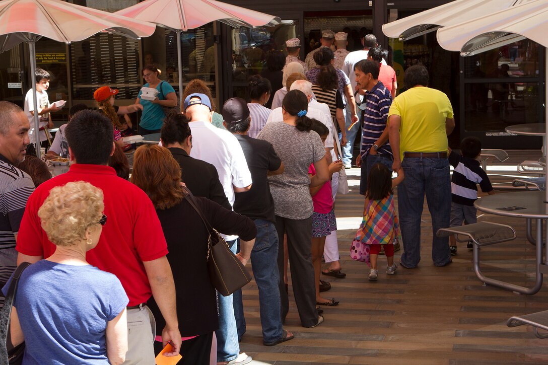A crowd of military members, Department of Defense employees and family members form a line during the grand opening of the food court aboard Marine Corps Air Station Miramar, Calif., June 16. The event marked the official opening of Wendy’s, Panda Express and Subway, and featured raffles, food giveaways, two bounce houses, a rock climbing wall, a balloon artist and a prize wheel. 