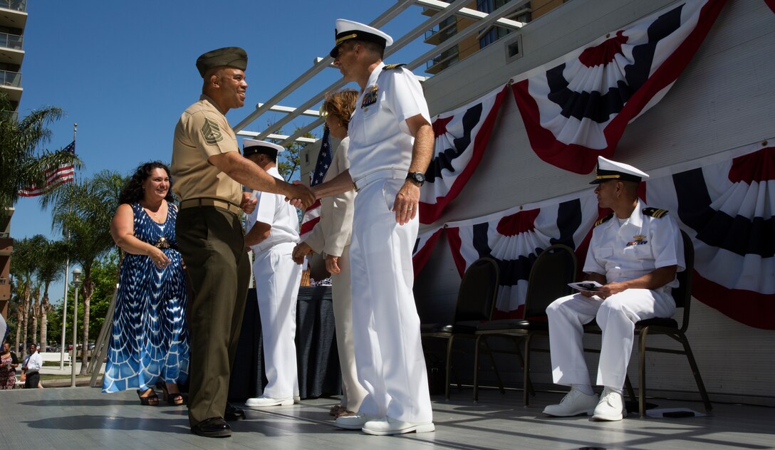 NAVAL BASE SAN DIEGO, Calif. – Gunnery Sgt. Kenneth Taylor, and his wife, Adela Taylor, left, receive their recognition certificates during the 6th annual San Diego Metro Academic Military Recognition Ceremony aboard Naval Base San Diego, Calif., June 13. Commanding officers from the installation spoke at the ceremony to express their pride for those who took the time to better themselves through continued education.