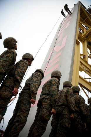 Two Lima Company recruits begin their journey down the 60-foot rappel tower while others await their opportunity at the bottom aboard Marine Corps Recruit Depot San Diego, June 6.