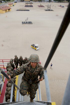 Recruit David Alvarez-Sanchez, Platoon 3274, Lima Company, makes his way to the top of the 60-foot tower aboard Marine Corps Recruit Depot San Diego, June 6.  Once at the top, recruit were checked for proper gear placement and descended the tower at the end of a rope.