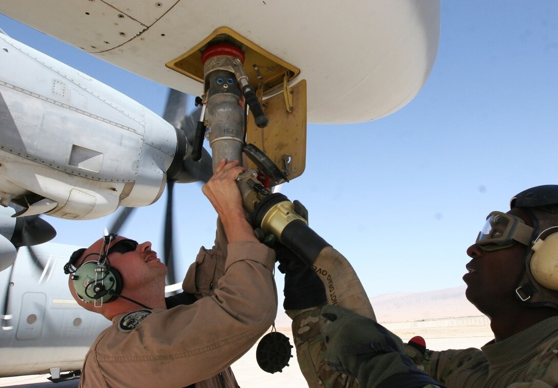 Sergeant Jacob Smith, a native of Moscow, Tenn., attaches a fueling hose to the refueling panel during an operation aboard Multi-National Base Command Tarin Kot, Afghanistan, June 8, 2014. During the operation, Smith, a crew master with Marine Aerial Refueler Transport Squadron 352, Regional Command (Southwest), provided needed fuel to MNBC Tarin Kot for their future operations. (U.S. Marine Corps photo by Cpl. Cody Haas/ Released)