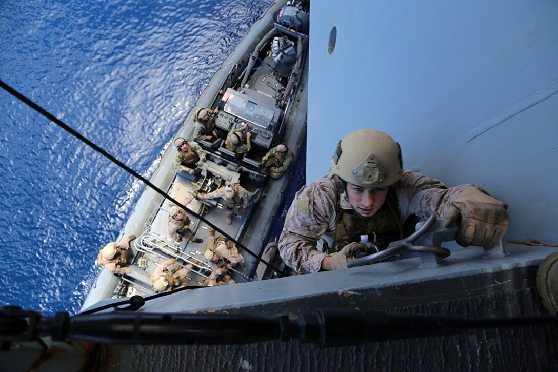 A Marine with the Force Reconnaissance Detachment, 11th Marine Expeditionary Unit, climbs up the USS San Diego on a caving ladder as part of an approach, hook and climb exercise conducted during Certification Exercise (CERTEX) off the coast of Southern California, June 13, 2014. The 11th MEU and Amphibious Squadron 5 team conduct CERTEX to hone mission-essential tasks, execute specified MEU and Amphibious Ready Group operations, and certify the foundation of a cohesive warfighting team for exercises and operations they may encounter in their upcoming deployment. (U.S. Marine Corps photo by Gunnery Sgt. Rome M. Lazarus/Released)