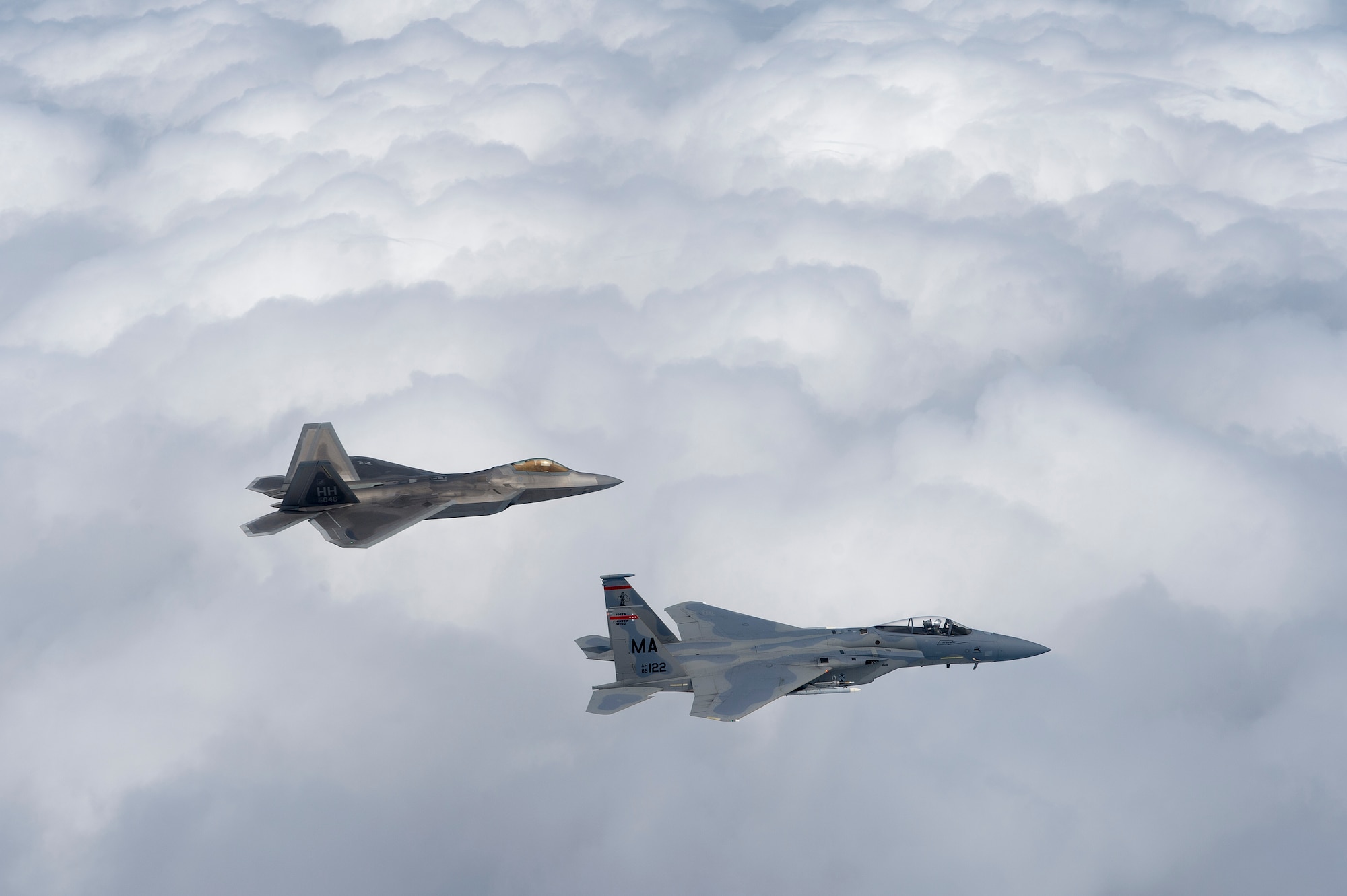 A U.S. Air Force F-22 Raptor from the 154th Wing, Joint Base Pearl Harbor-Hickam, Hawaii, and U.S. Air Force F-15 Eagle from the 131st Fighter Squadron, 104th Fighter Wing, Barnes Air National Guard Base, Mass., fly over Penang, Malaysia, during Cope Taufan 14, June 16, 2014. Cope Taufan is a biennial large force employment exercise taking place June 9 to 20 designed to improve U.S. and Malaysian combined readiness. (U.S. Air Force photo by Tech. Sgt. Jason Robertson/Released) 