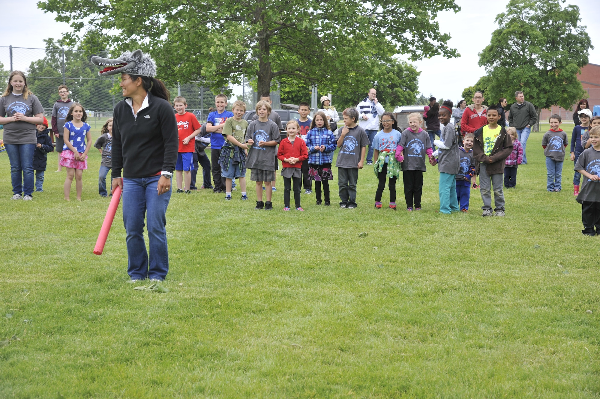 Sandy Zimmerman plays a game with children at Fairchild Air Force Base, Wash., June 14, 2014. Zimmerman and her family put together the event called Celebrate Military Children in honor of her father, an Army veteran, whose passion was to stay physically fit and active. Zimmerman is a physical education teacher at Michael Anderson Elementary School. (U.S. Air Force photo by Senior Airman Mary O'Dell/Released)
