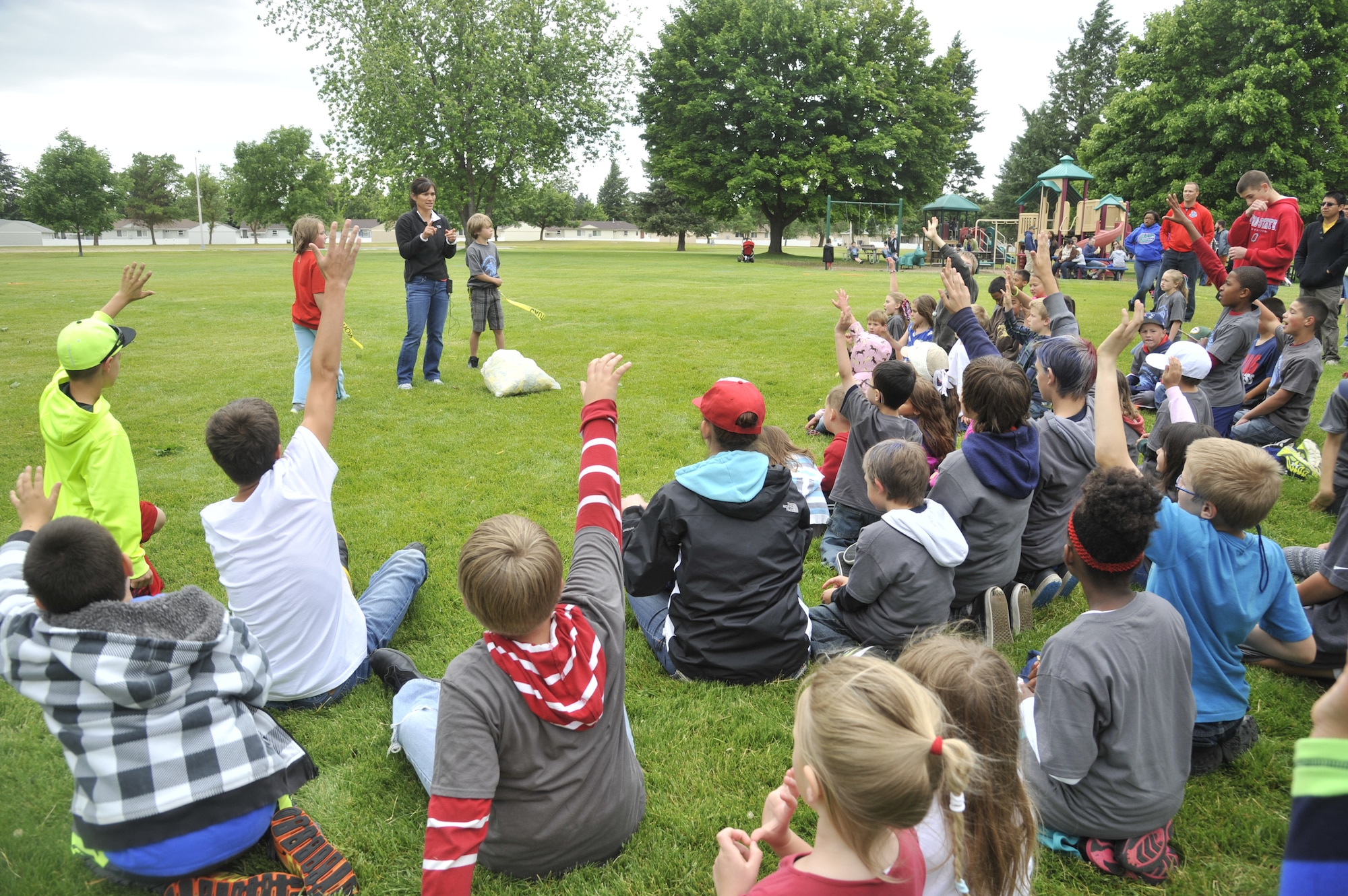 Sandy Zimmerman asks for volunteers to demonstrate how a game is played during an event at Fairchild Air Force Base, Wash., June 14, 2014. Zimmerman held this event, called "Celebrate Military Children," to honor the kids who also carry the burden of military service. Zimmerman is a physical education teacher at Michael Anderson Elementary School. (U.S. Air Force photo by Senior Airman Mary O'Dell/Released)