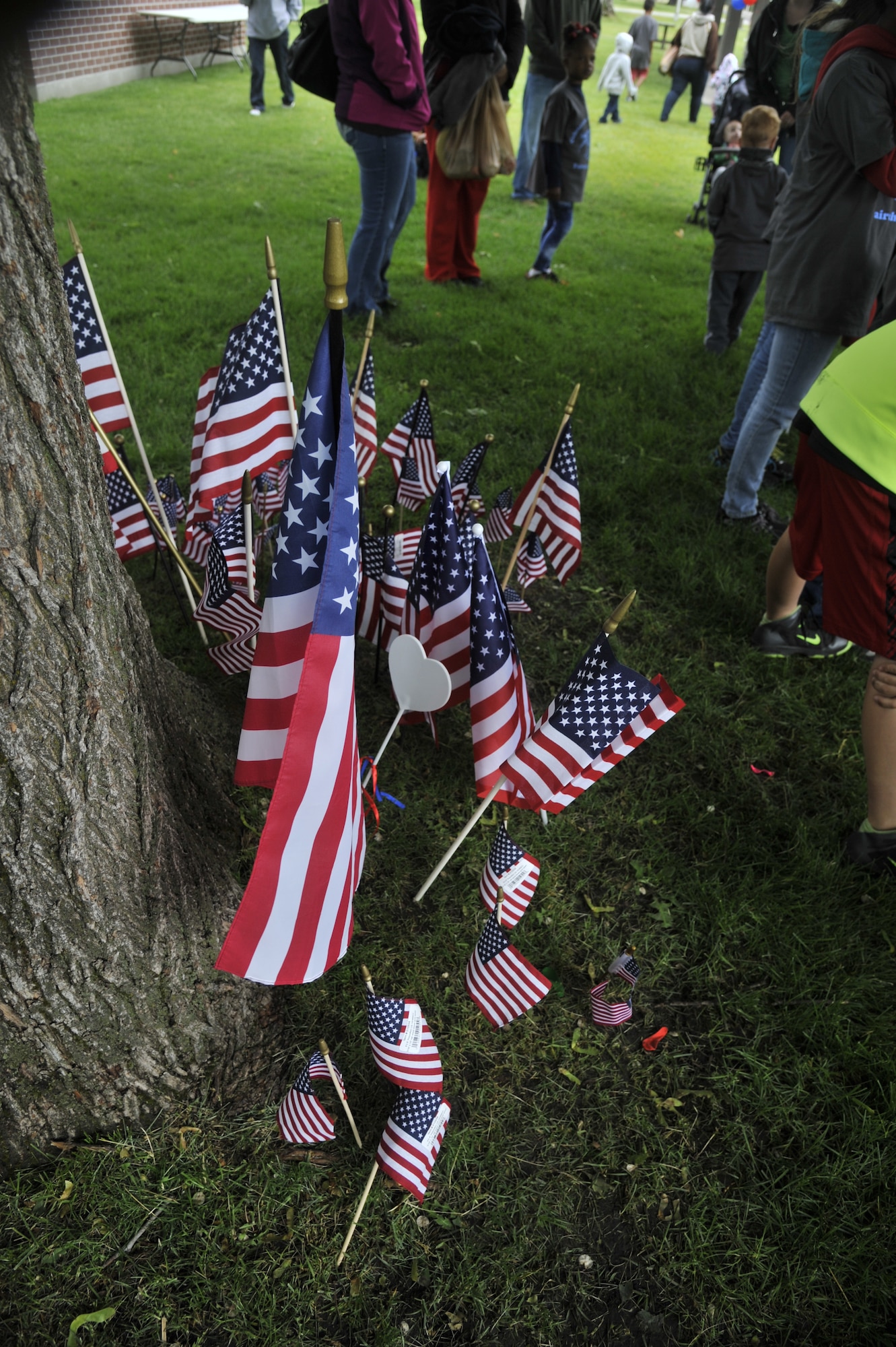 Flags donated by families that attended the Celebrate Military Children event are gathered under a tree at Fairchild Air Force Base, Wash., June 14, 2014. More than 200 families registered to participate in this event, open to all members with base access, donating the flags to a local veterans cemetery. (U.S. Air Force photo by Senior Airman Mary O'Dell/Released)