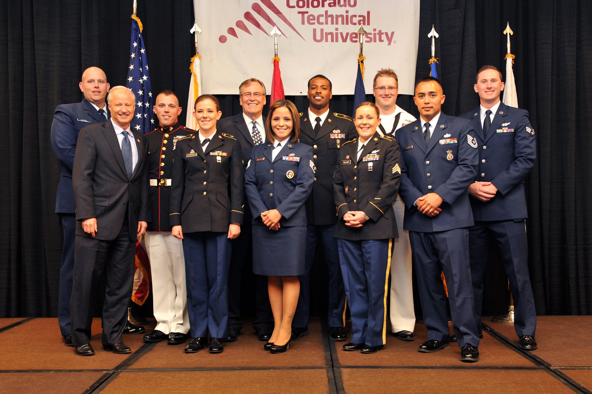 Winners from the 38th Annual Armed Forces Recognition Luncheon gather for a group photo June 13, 2014, at the Doubletree Hotel in Denver. The Aurora Chamber of Commerce and Defense Council recognized 11 military members from all branches and components for their achievements on and off duty. (U.S. Air Force photo by Airman Emily E. Amyotte/Released)