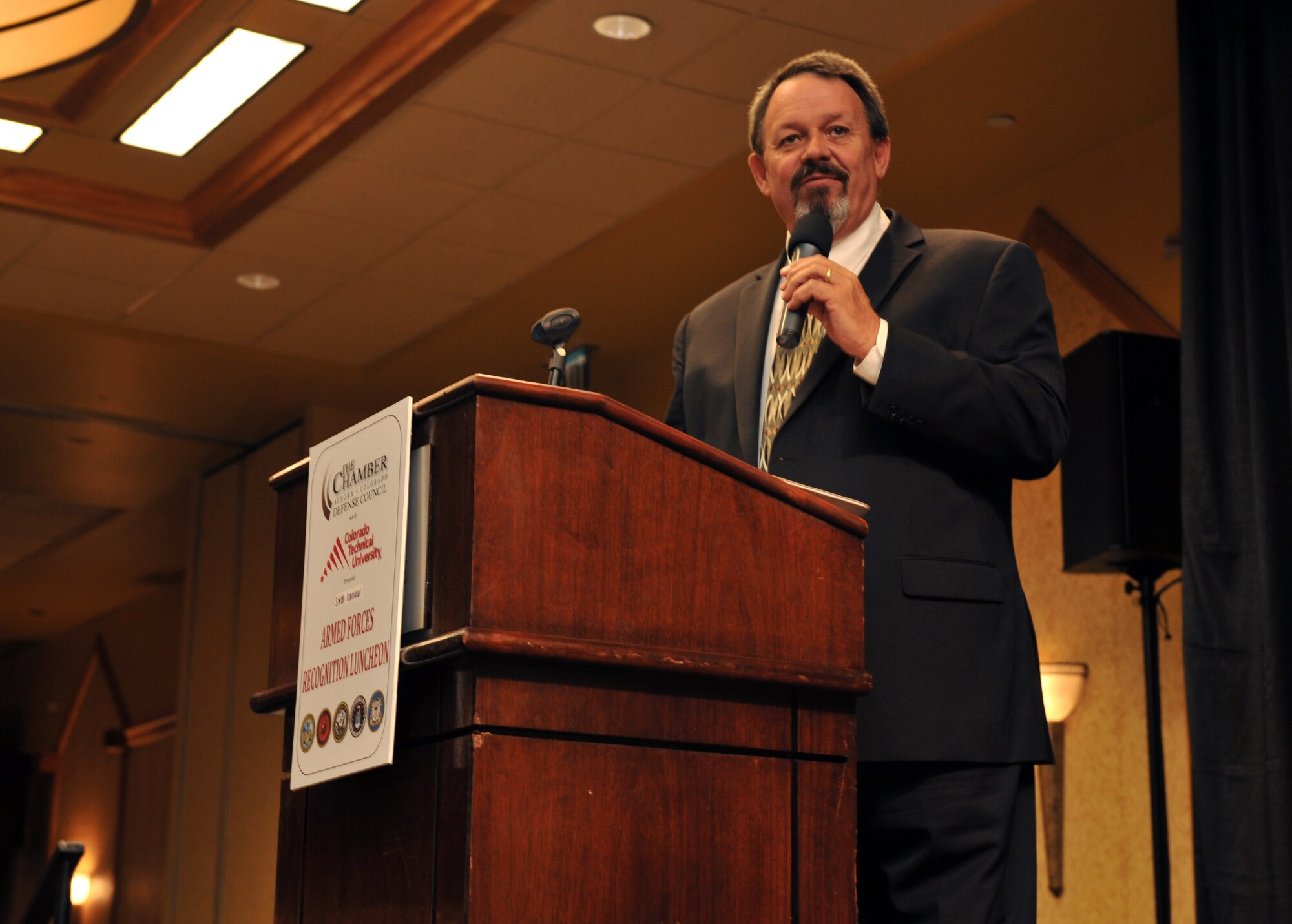 Rick Crandall, 38th Annual Armed Forces Recognition Luncheon master of ceremonies, speaks to the audience on the achievements of award winners June 13, 2014, at the Doubletree Hotel in Denver. The Armed Forces Recognition Luncheon recognized 11 award winners from all branches and components of the military. (U.S. Air Force photo by Airman Emily E. Amyotte/Released)