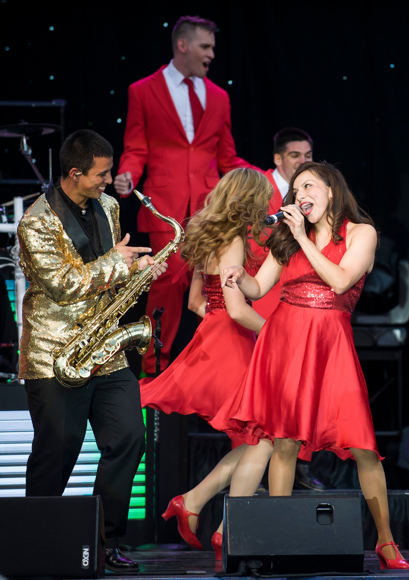 U.S. Air Force Senior Airman Mayra Hernandez, 366th Medical Group nutritional medicine journeyman and Tops In Blue female vocalist, performs during a Tops In Blue concert at Mountain Home Air Force Base, Idaho, June 15, 2014. The Tops In Blue team serves as an expeditionary entertainment unit to provide quality entertainment from within Air Force resources for the Air Force family. (U.S. Air Force photo by Airman 1st Class Brittany A. Chase/Released)