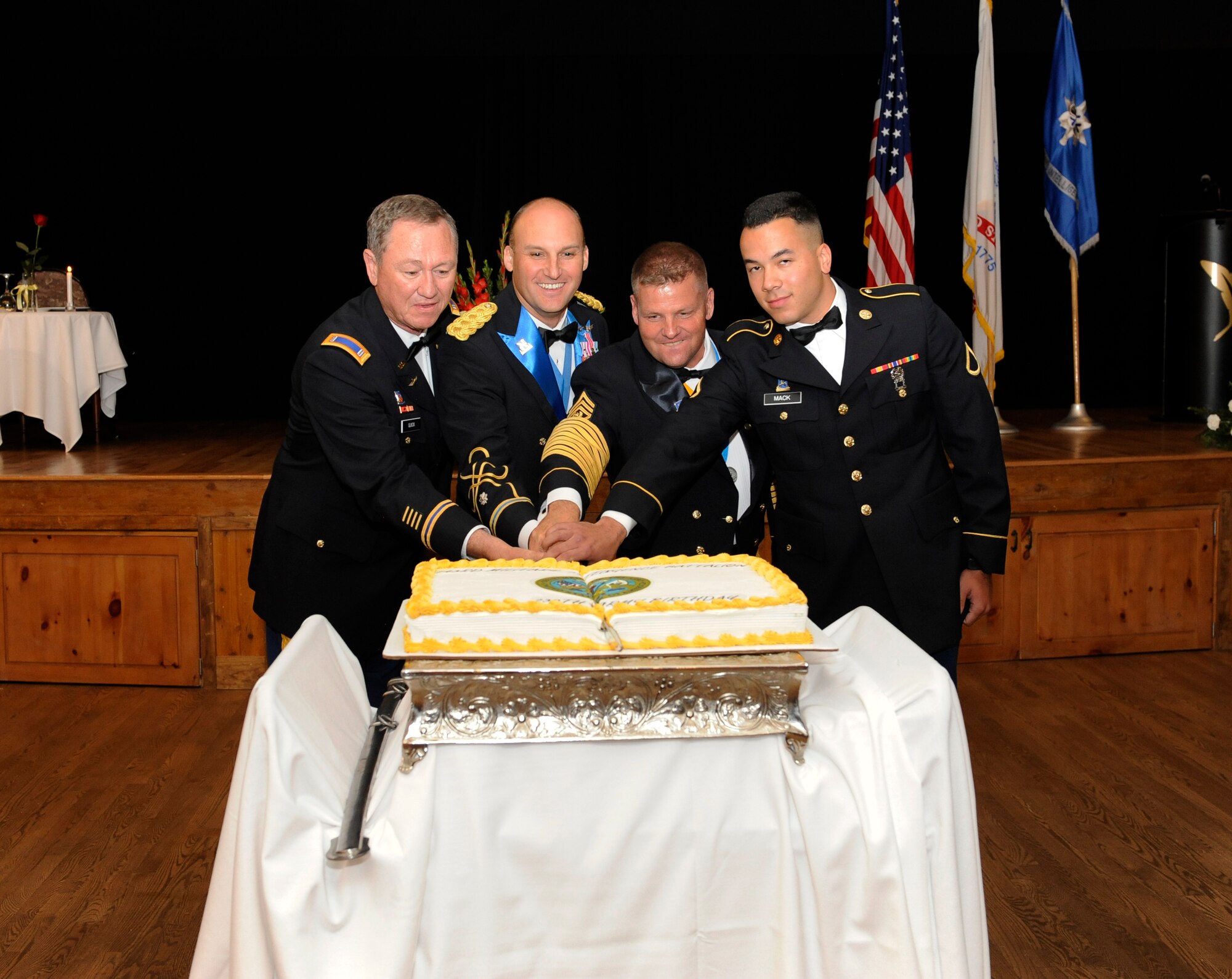 The oldest and youngest member of the 743rd Military Intelligence Battalion join their leadership to ceremoniously cut the cake during the 743rd MIB Army Ball June 14, 2014, at the Heritage Eagle Bend Golf Club in Denver, Colo.  The ball celebrated the Army’s 239th birthday and included a formal dinner with guest speakers. (U.S. Air Force photo by Airman 1st Class Samantha Saulsbury/Released)