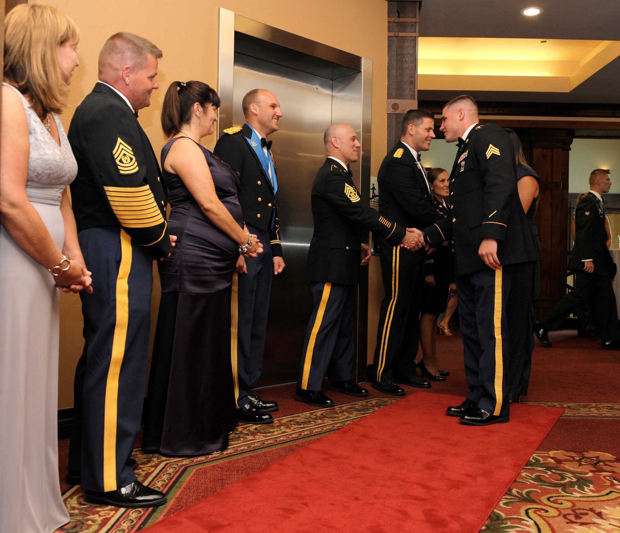 Members of the 743rd Military Intelligence Battalion leadership introduce themselves to attendees of the 743rd MIB Army Ball June 14, 2014, at the Heritage Eagle bend Golf Club in Denver, Colo. The ball celebrated the Army’s 239th birthday which included a formal dinner, guest speakers and a ceremonial cake cutting. (U.S. Air Force photo by Airman 1st Class Samantha Saulsbury/Released)