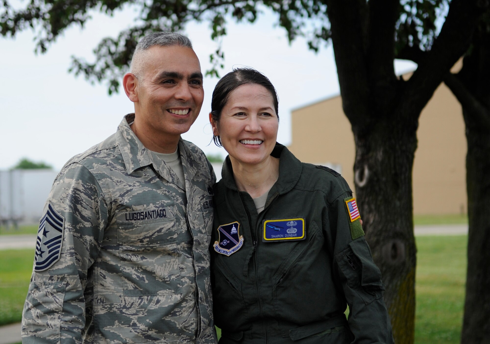 Chief Master Sgt. Jose A. LugoSantiago, Air Force District of Washington command chief, poses for a photo with Maj. Gen. Sharon K. G. Dunbar after her fini-flight celebration at Joint Base Andrews, Md., June 13, 2014. Dunbar, the AFDW Commander will be retiring in July after 32 years of service. (U.S. Air Force photo/ Senior Airman Nesha Humes)