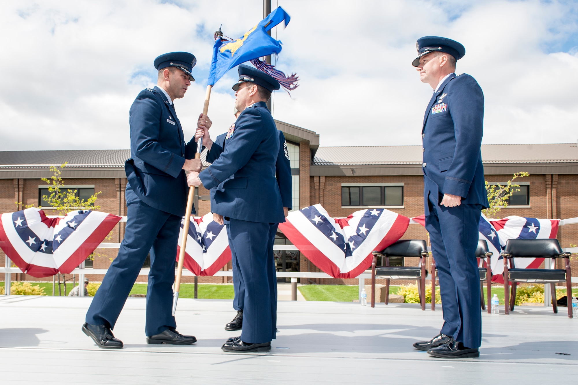 Col. Jonathan Duncan receives command of the 336th Training Group from Col. Vincent Becklund as Col. William “Bill” Thomas watches during the 336th TRG’s change of command ceremony at Fairchild Air Force Base, Wash., June 16, 2014. Becklund is the 58th Special Operations Wing commander and administrative home to the 336th TRG at Kirtland Air Force Base, N.M. Thomas, who retires after 24 years in August, served as the 336th TRG commander for more than two years earning dozens of accolades in his short tenure. Duncan comes to Fairchild from an assignment at Hurlburt Field, Fla., where he served as the Chief, Programs Division, Headquarters Air Force Special Operations. The 336th TRG is the sole manager of all U.S. Air Force Survival, Evasion, Resistance and Escape training. Its mission is to provide at risk of isolation personnel with the skills and confidence to “Return with Honor.” (U.S. Air Force photo by Staff Sgt. Benjamin W. Stratton/Released)