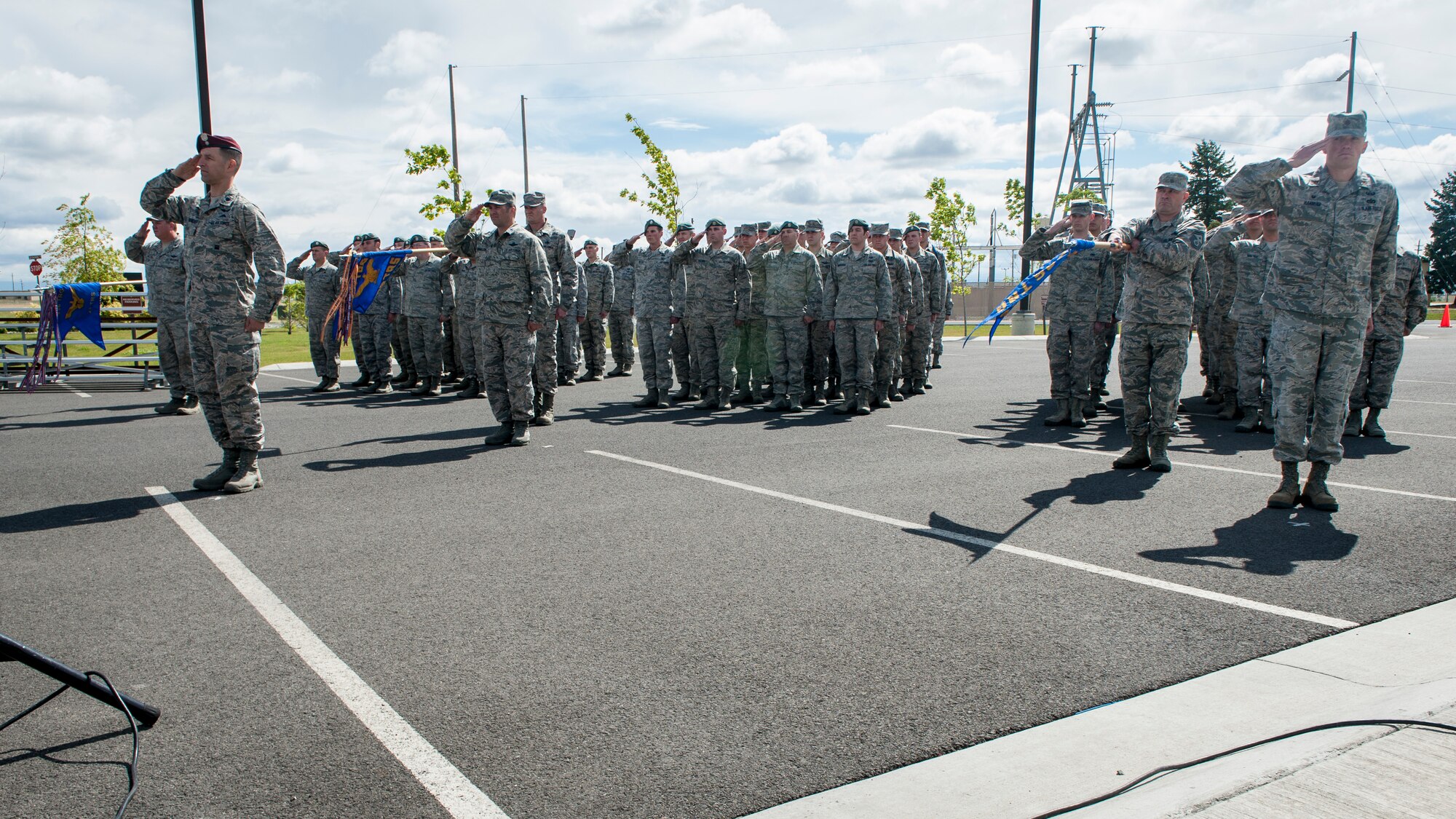 Airmen salute in formation during the 336th Training Group’s change of command ceremony at Fairchild Air Force Base, Wash., June 16, 2014. Col. Jonathan Duncan took command of the group from retired Col. William “Bill” Thomas. Duncan comes to Fairchild from an assignment at Hurlburt Field, Fla., where he served as the Chief, Programs Division, Headquarters Air Force Special Operations. The 336th TRG is the sole manager of all U.S. Air Force Survival, Evasion, Resistance and Escape training. Its mission is to provide at risk of isolation personnel with the skills and confidence to “Return with Honor.” (U.S. Air Force photo by Staff Sgt. Benjamin W. Stratton/Released)