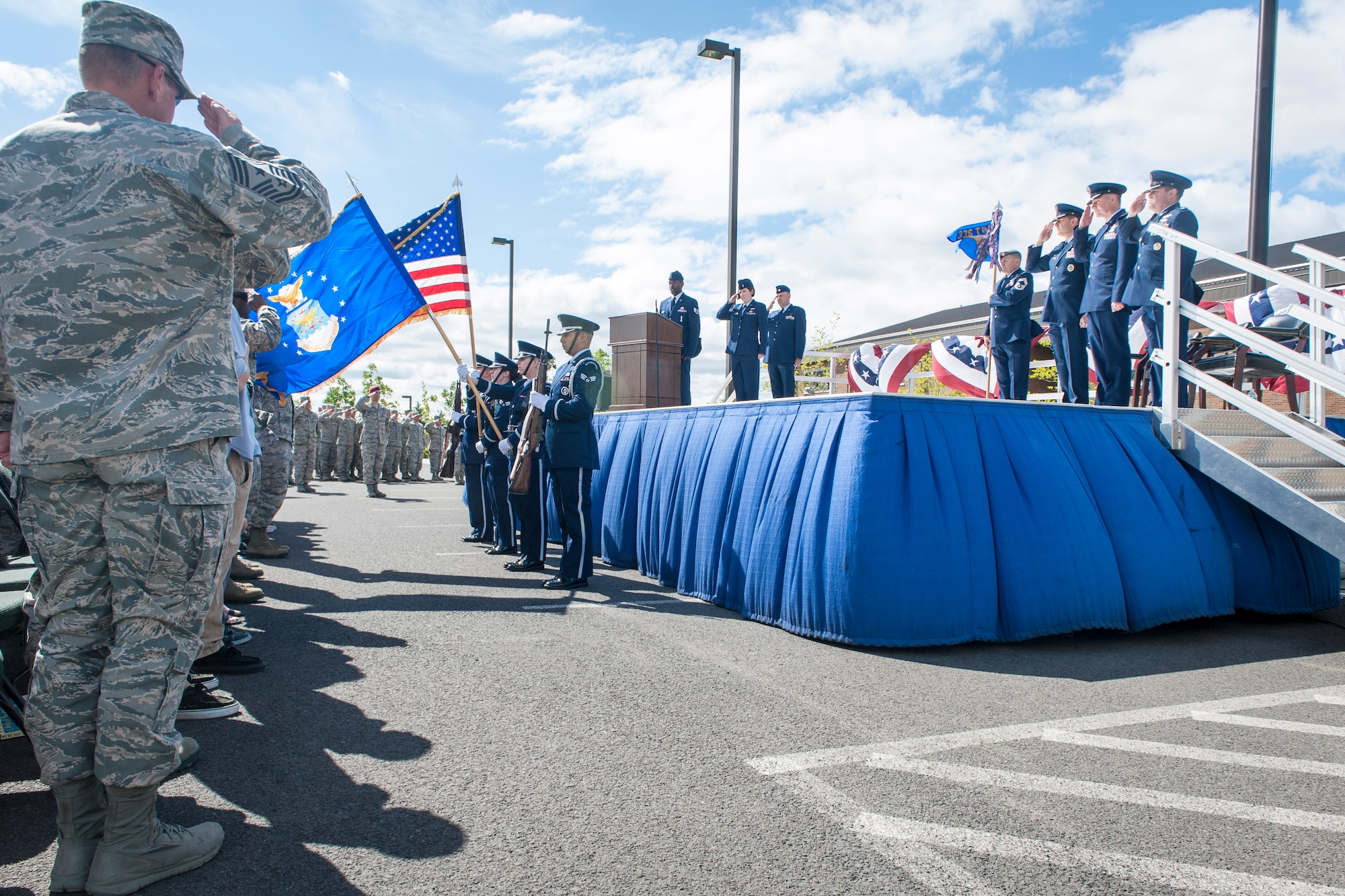 Fairchild Airmen and guests salute and pay respect to the American flag during the singing of the National Anthem as part of the 336th Training Group’s change of command ceremony at Fairchild Air Force Base, Wash., June 16, 2014. The 336th TRG is the sole manager of all U.S. Air Force Survival, Evasion, Resistance and Escape training. Its mission is to provide at risk of isolation personnel with the skills and confidence to “Return with Honor.” (U.S. Air Force photo by Staff Sgt. Benjamin W. Stratton/Released)