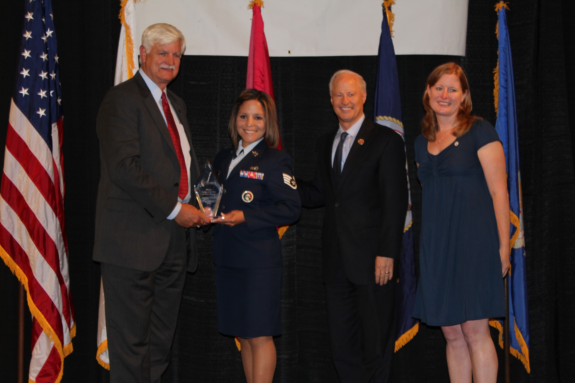 Bob Schlue from Boeing, Congressman Mike Coffman, U.S. House of Representatives, serving the 6th District of Colorado, and Kelly Sullivan Loughren, granddaughter of Albert Sullivan, one of the five famed Sullivan brothers who were killed in World War II, present the Air Force Reservist of the year award to Staff Sgt. Iris Morales during the 38th Annual Armed Forces Recognition Luncheon held June 13, 2014, at the Double Tree by Hilton in Denver. The luncheon, sponsored by Colorado Technical University, included an awards ceremony that recognized 11 military members and one civilian from the community for their outstanding achievements during the past year. (U.S. Air Force photo/Tech. Sgt. Rob Hazelett)
