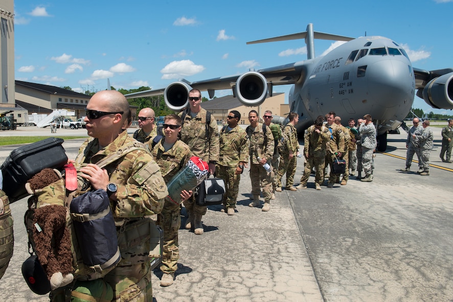 Moody Airmen file off of a C-17 Globemaster III during a deployment return at Moody Air Force Base, Ga., June 10, 2014. The Airmen were deployed to the 455th Air Expeditionary Wing at Bagram Airfield, Afghanistan for four months. (U.S. Air Force photo by Airman 1st Class Ryan Callaghan/Released)