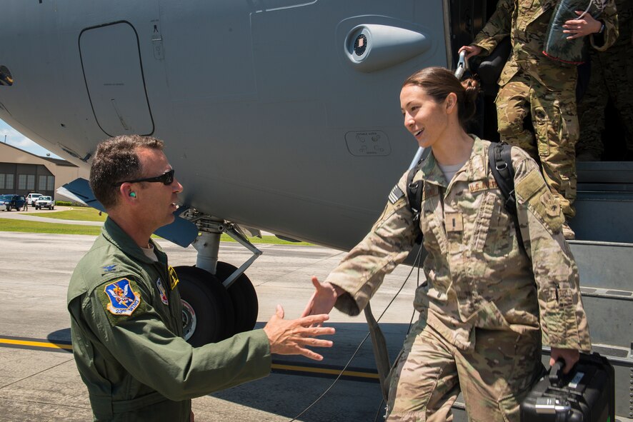 U.S. Air Force Col. Chad Franks, left, 23d Wing commander, shakes hands with 1st Lt. Fumiko Hedlund, 41st Rescue Squadron chief of intel, during a deployment return at Moody Air Force Base, Ga., June 10, 2014. Hedlund was assigned to the 83d Expeditionary Rescue Squadron at Bagram Airfield Afghanistan. (U.S. Air Force photo by Airman 1st Class Ryan Callaghan/Released)