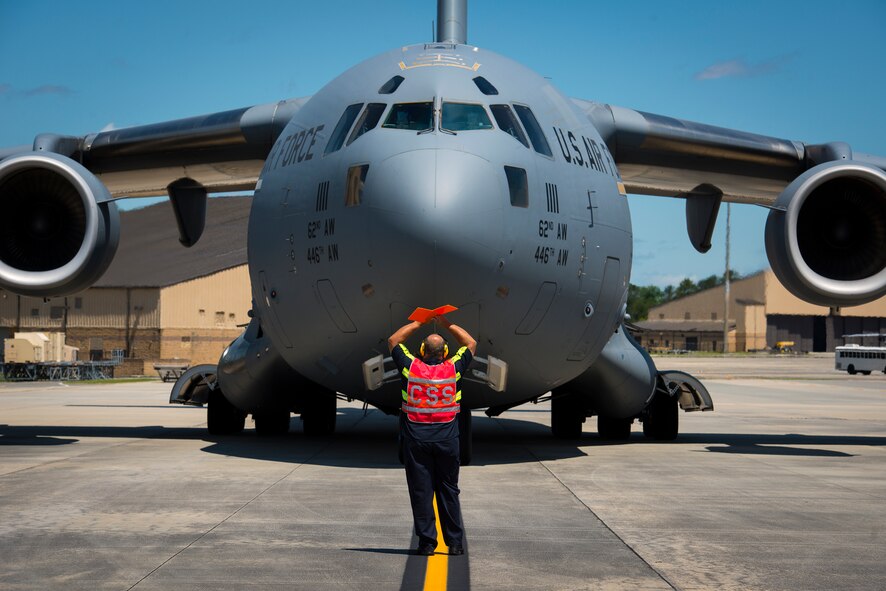 A C-17 Globemaster III carrying Moody Airmen taxis to its parking space during a deployment return at Moody Air Force Base, Ga., June 10, 2014. More than 80 Moody Airmen returned from deployments on June 10 and 11. (U.S. Air Force photo by Airman 1st Class Ryan Callaghan/Released)