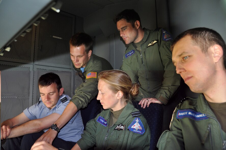 Royal Air Force Eurofighter Typhoon pilots get their first view of the boom area of the KC-10 Extender June 6, after completing an air refueling training mission with the Reserve aircrew that flew the tanker. Senior Airman Gregory Coburn, a member with the 78th Air Refueling Squadron at Joint Base McGuire-Dix-Lakehurst, N.J., gives the tour of the tanker’s boom area and explains how he operates the drogue, which allows the fuel to flow from the tanker to the fighters. (U.S. Air Force photo/Master Sgt. Donna T. Jeffries)