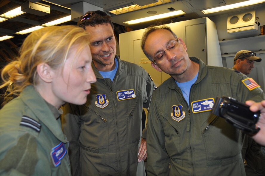 Royal Air Force Flt. Lt. Tori Turner, left, views the video taken of her piloting the Eurofighter Typhoon while performing an infrequent refueling training mission with the KC-10 Extender tanker June 6. Reserve tanker pilots, Lt. Cols. Todd Brace and Greg Dipenta, middle and  right, of the 78th Air Refueling Squadron from Joint Base McGuire-Dix-Lakehurst, N.J., were part of the crew that refueled seven Typhoons during the D-Day training flight, which took place along a refueling track near Royal Air Force Leuchars, United Kingdom. (U.S. Air Force photo/Master Sgt. Donna T. Jeffries)