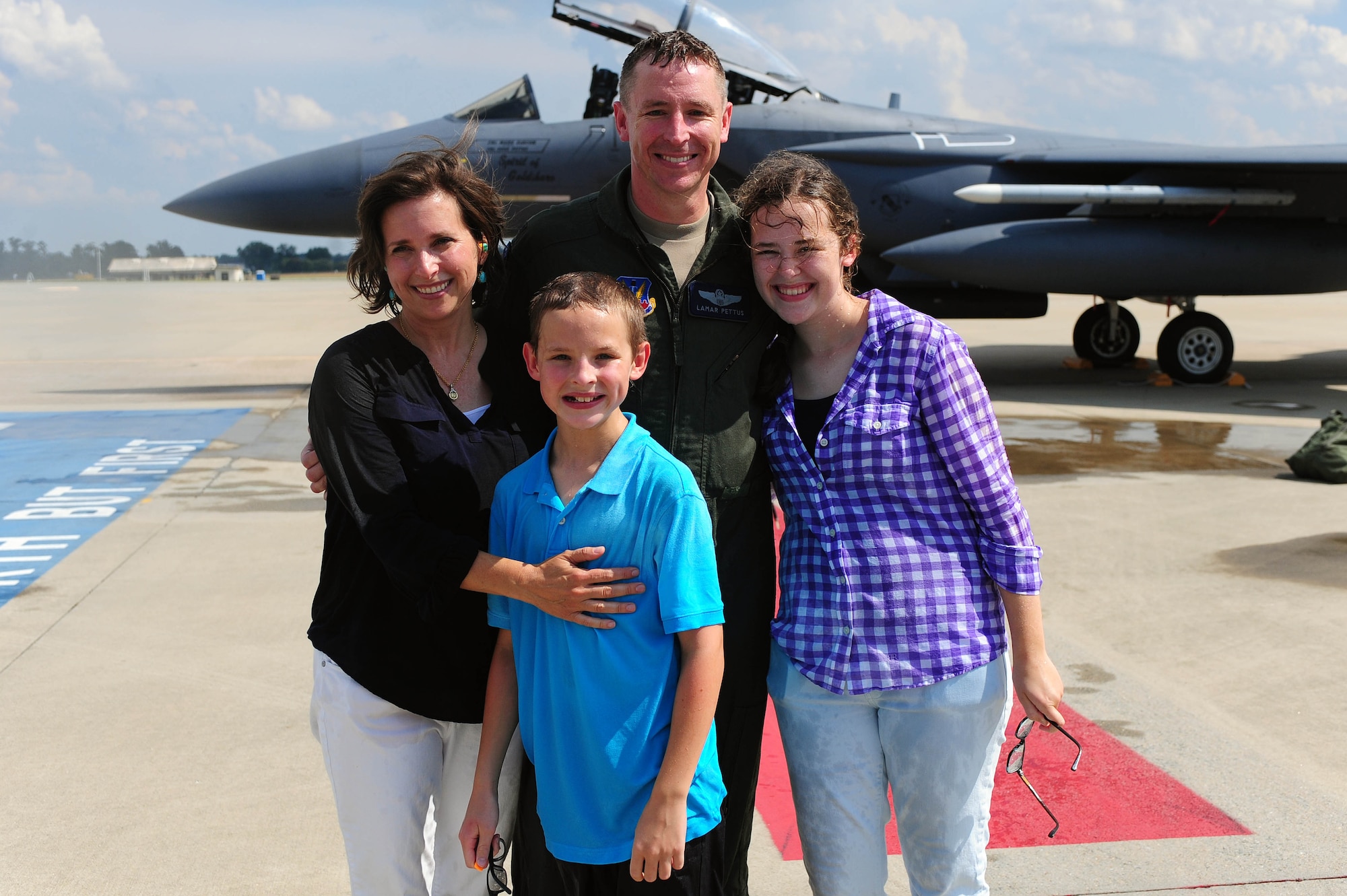 Col. Lamar Pettus, 4th Fighter Wing vice commander, poses for a photo with his family after his fini-flight, June 13, 2014, at Seymour Johnson Air Force Base, North Carolina. A fini-flight is a military aviation tradition that marks the end of a pilot’s or commander’s time at a location or command. (U.S. Air Force photo/Senior Airman John Nieves Camacho)