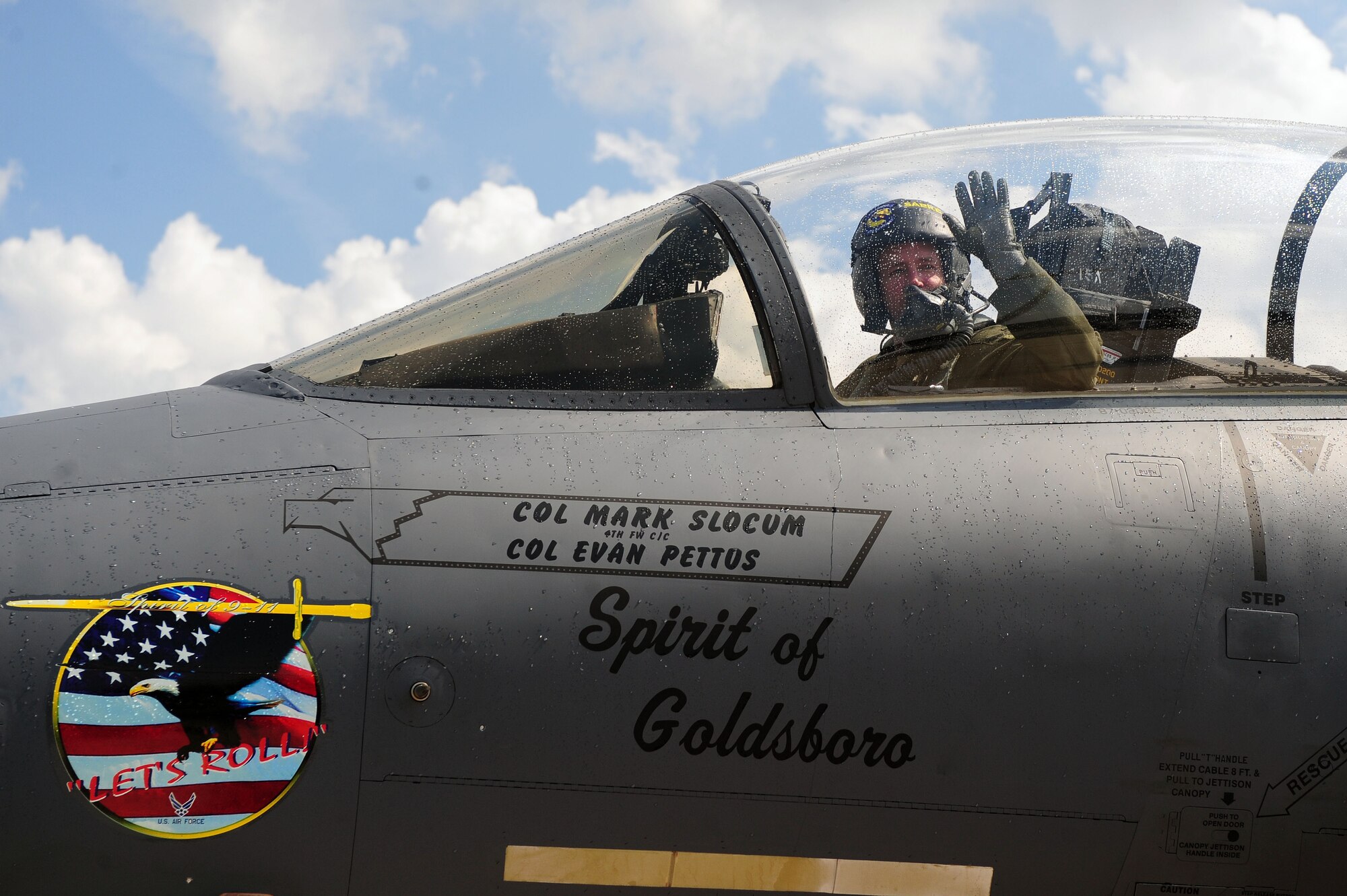Col. Lamar Pettus, 4th Fighter Wing vice commander, waves to his family after his fini-flight, June 13, 2014, at Seymour Johnson Air Force Base, North Carolina. A fini-flight is a military aviation tradition that marks the end of a pilot’s or commander’s time at a location or command. (U.S. Air Force photo/Senior Airman John Nieves Camacho)