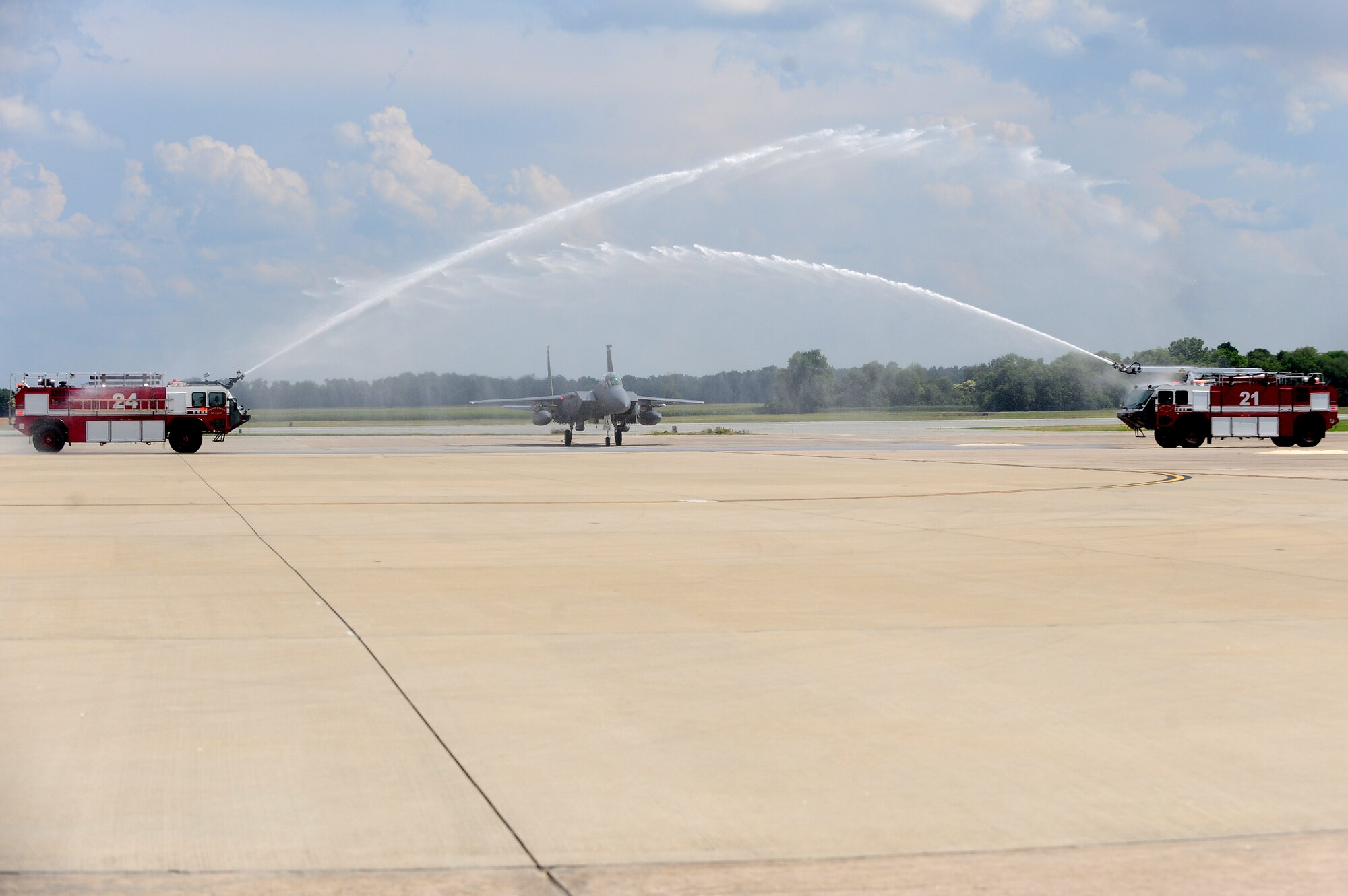 Col. Lamar Pettus, 4th Fighter Wing vice commander, passes through a water arc after his fini-flight, June 13, 2014, at Seymour Johnson Air Force Base, North Carolina. A fini-flight is a military aviation tradition that marks the end of a pilot’s or commander’s time at a location or command. (U.S. Air Force photo/Senior Airman John Nieves Camacho)
