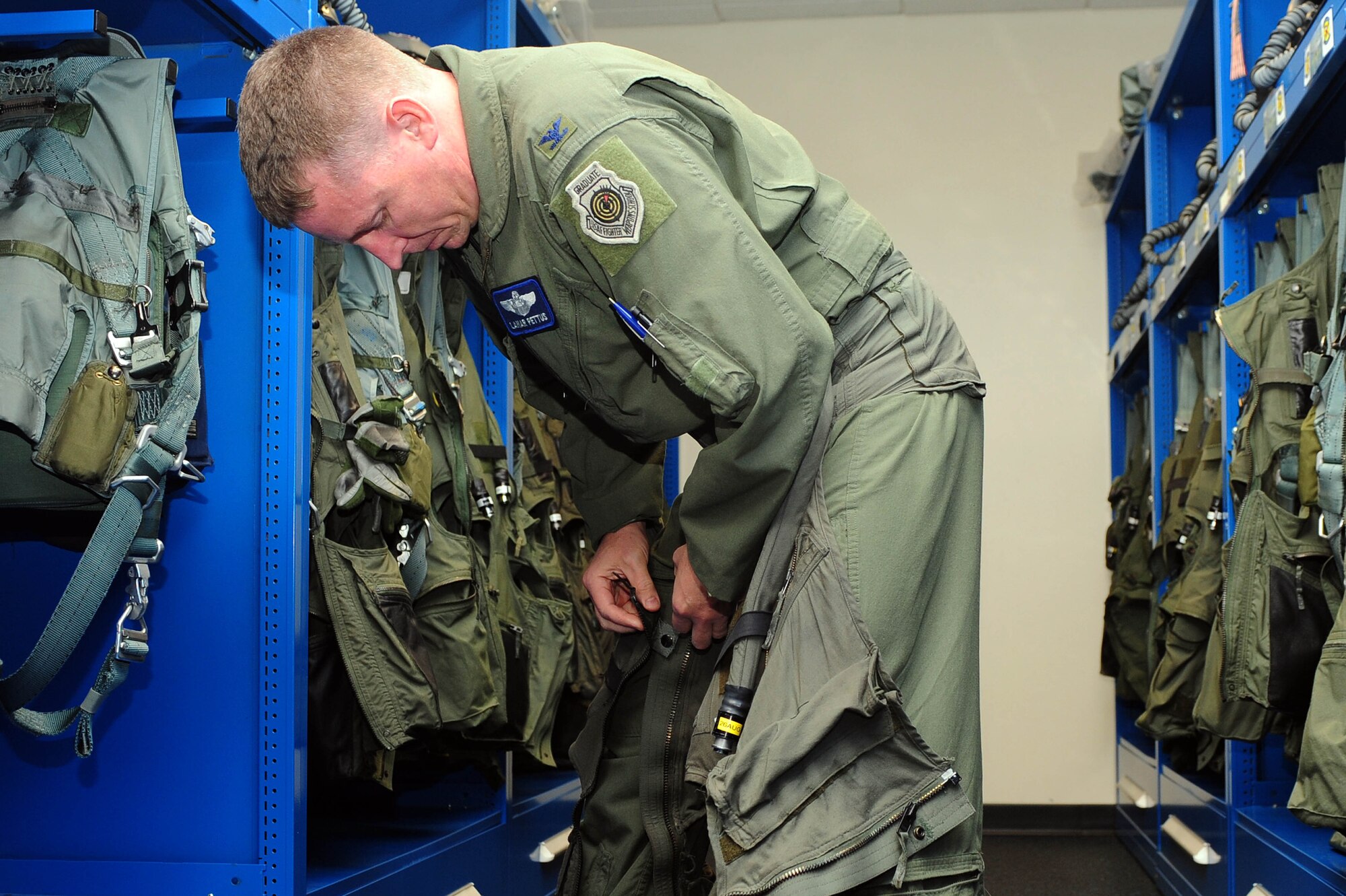 Col. Lamar Pettus, 4th Fighter Wing vice commander, suits up for his fini-flight, June 13, 2014, at Seymour Johnson Air Force Base, North Carolina. A fini-flight is a military aviation tradition that marks the end of a pilot’s or commander’s time at a location or command. (U.S. Air Force photo/Senior Airman John Nieves Camacho)