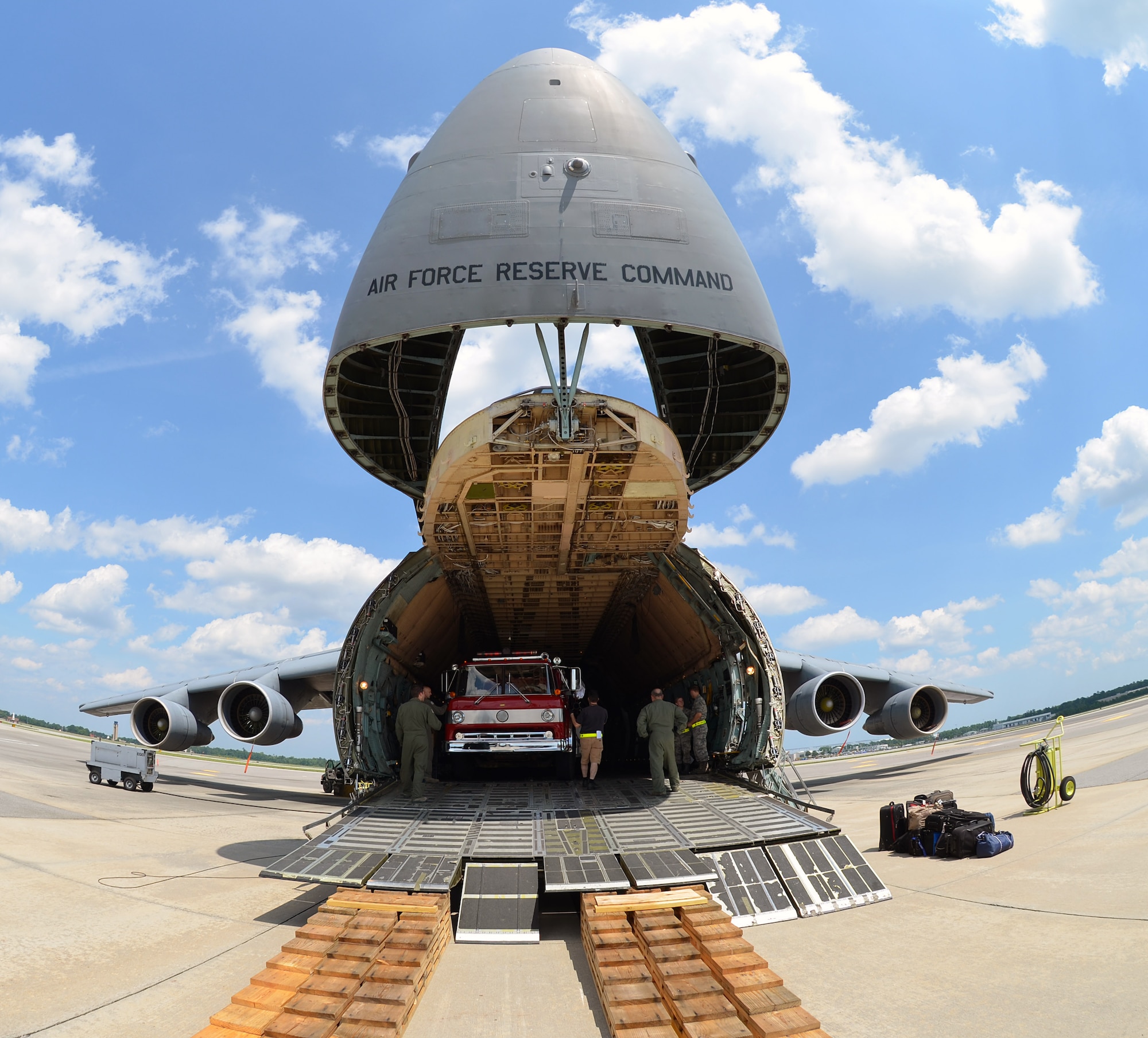 A Ford Horton Ambulance, a Ford 8000 Pierce Pumper and a Ford C-8000 Pirsch Pumper are loaded into the Westover C-5 Galaxy aircraft at JB-Charleston June 9, 2014. The cargo was delivered to Managua, Nicaragua June 10, on behalf of the Wisconsin/Nicaragua Partners of the Americas, Incorporated. (U.S. Air Force photo/SSgt. Kelly Goonan)