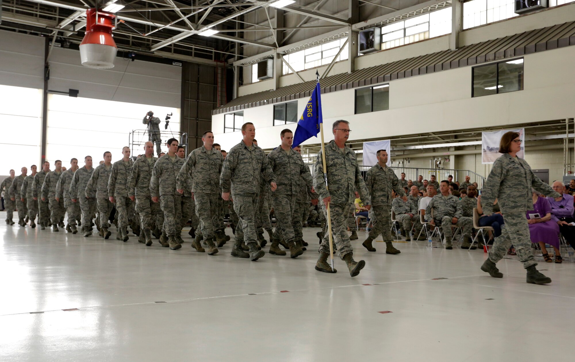 Chief Master Sgt. Tomie Allinder carries the 123rd Intelligence Squadron guidon as Lt. Col. Tina Lipscomb, 123rd IS commander, marches in front. The 188th Wing welcomed the already-established 123rd Intelligence Squadron into its wing under the 188th Intelligence, Surveillance and Reconnaissance Group during a Conversion Day ceremony held at Ebbing Air National Guard Base, Fort Smith, Arkansas, June 7, 2014. The 123rd IS will move from its current location at Little Rock Air Force Base, Arkansas. The ceremony recognized the many changes occurring at the wing as a result of its conversion to a remotely piloted aircraft (MQ-9 Reapers) and intelligence, surveillance and reconnaissance mission. The 188th Fighter Wing was redesignated as the 188th Wing during the event. (U.S. Air National Guard photo by Master Sgt. Mark Moore)