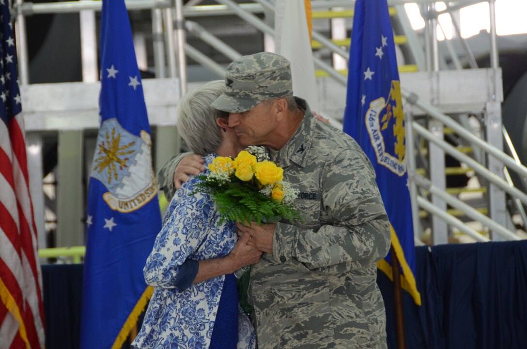 Col. Richard Nyalka, the 126th Mission Support Group commander, presents his wife, Diane Nyalka, with flowers when retiring at Scott Air Force Base, Ill., May 3, 2014. Nyalka was the commander for the 126th Mission Support Group attached to the 126th Air Refueling Wing in the Illinois Air National Guard for 15 years. (Air National Guard photo by Senior Airman Elise Stout)