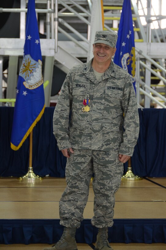 Col. Richard Nyalka, the 126th Mission Support Group commander, receives applause after receiving the Silver Circle Pin. The Silver Circle Pin is awarded to retiring wing members who have served at least twenty years of military service with at least ten years in the Illinois Air National Guard.  (Air National Guard photo by Senior Airman Elise Stout)