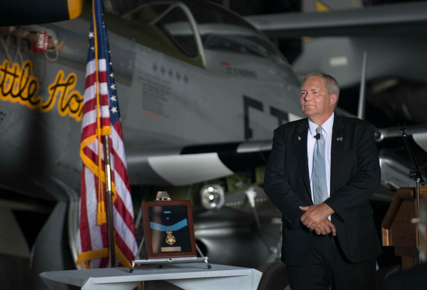Cory Etchberger stands by his father’s Medal of Honor during the Military Affairs Committee lunch at the Minot Air Museum in Minot, N.D., June 5, 2014. Etchberger’s father, Chief Master Sgt. Richard L. Etchberger, received the Medal of Honor posthumously in 2010, after he was killed in Laos in 1968. (U.S. Air Force photo/Airman 1st Class Lauren Pitts) 
