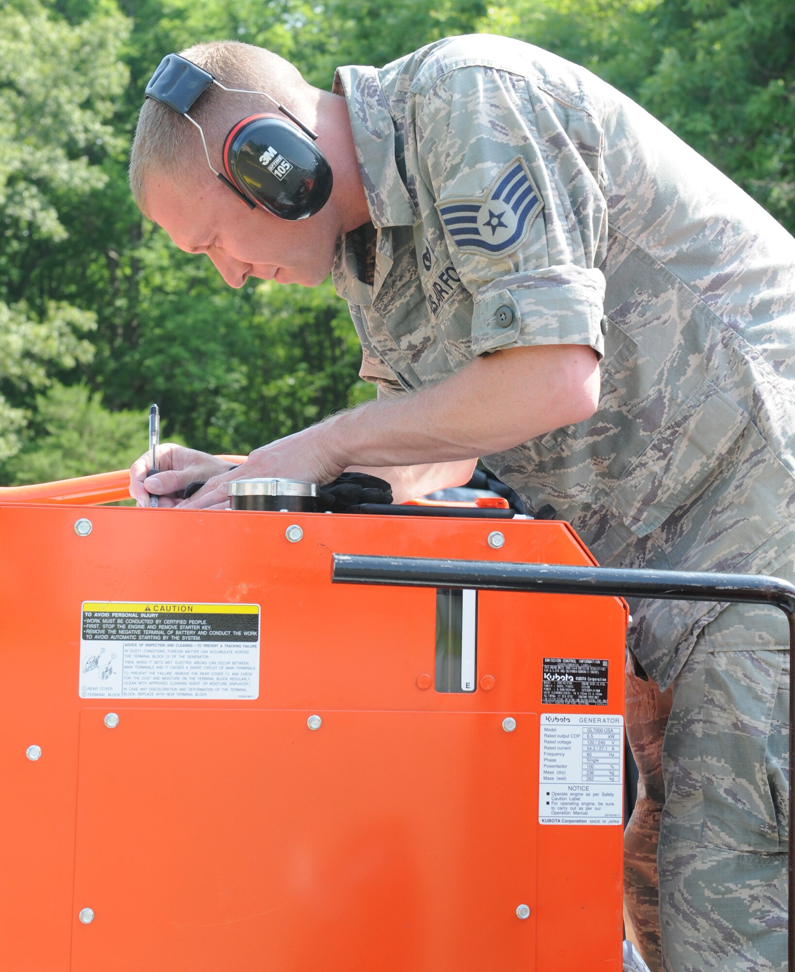 Staff Sgt. John E. Tascoe, an electrical power production apprentice with the 910th Communications Squadron, Youngstown Air Reserve Station, Ohio, inspects generators during the Quartermaster Liquid Logistics Exercise (QLLEX) at Fort A.P. Hill, Va., June 8, 2014. The Air Force is providing internet and communication support for QLLEX. (US Army photo by Nicole R. Paese/Released)