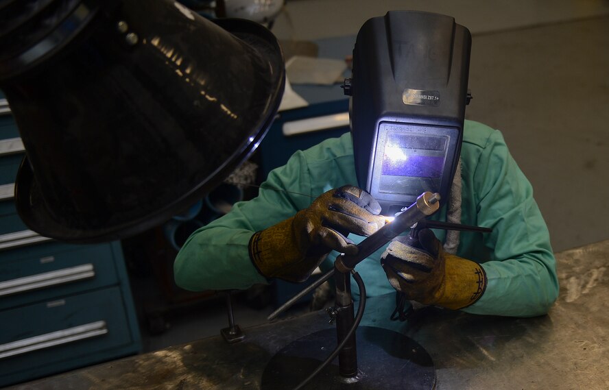 Airman 1st Class Thomas Tangedal, 22nd Maintenance Squadron metals technician, welds a certification tube, June 11, 2014, at McConnell Air Force Base, Kan. The tube must pass a nondestructive inspection after being welded in order for the welder to receive their job certification. (U.S. Air Force photo/Airman 1st Class Colby Hardin)