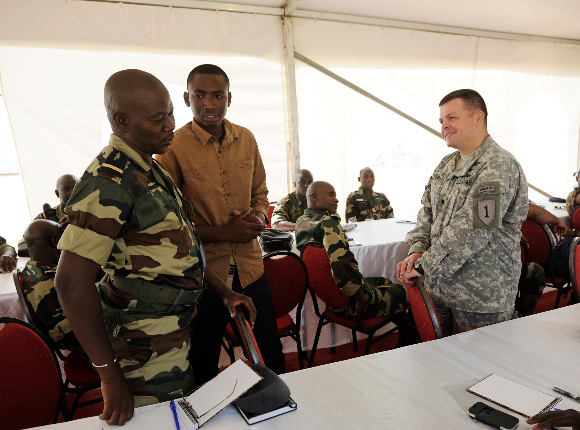 Army Lt. Col. James Tenpenny, U.S. Army Africa mission planner, instructs Airmen from multiple countries during African Partnership Flight in Dakar, Senegal, June 16, 2014. U.S. Air Forces in Europe and Air Forces Africa Airmen are in Senegal for APF, a program designed to improve communication and interoperabilty between regional partners in Africa. The African partners include Senegal, Togo, Burkina Faso, Benin, Ghana, Mauritania, Nigeria and Niger with the U.S. helping with organization. (U.S. Air Force photo/ Staff Sgt. Ryan Crane)