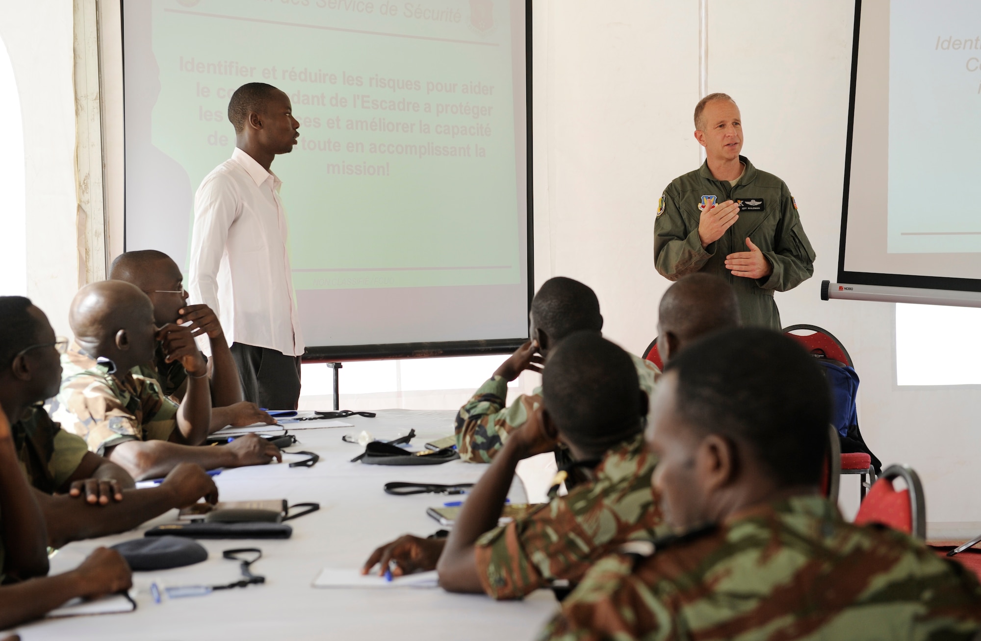 Lt. Col. Jeff Waldman, 129th Rescue Wing safety officer, instructs Airmen from multiple countries during African Partnership Flight in Dakar, Senegal, June 16, 2014. U.S. Air Forces in Europe and Air Forces Africa Airmen are in Senegal for APF, a program designed to improve communication and interoperabilty between regional partners in Africa. The African partners include Senegal, Togo, Burkina Faso, Benin, Ghana, Mauritania, Nigeria and Niger with the U.S. helping with organization. (U.S. Air Force photo/ Staff Sgt. Ryan Crane)