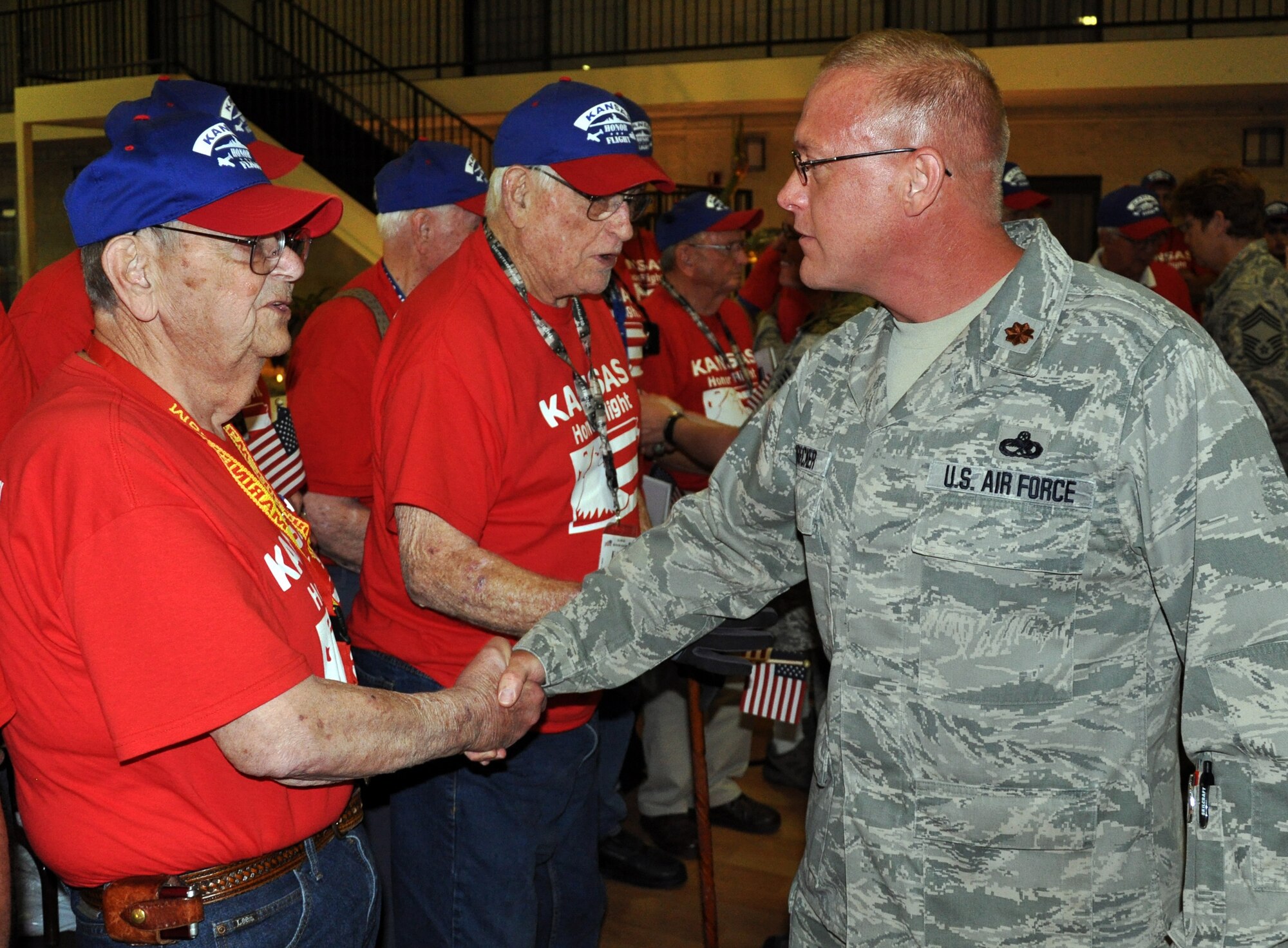 Maj. John Neubecker, 931st Air Refueling Group, shakes the hand of a local Korean War Veteran and thanks him for his service during an Honor Flight welcome home ceremony in Wichita, Kan., June 13, 2014. Neubecker was one of more than 40 members of Team McConnell on hand to greet 21 World War II and Korean War Veterans as they returned from an Honor Flight to Washington, D.C. Honor Flights are conducted by a non-profit organization, and take Veterans to see their war memorials and other sites in the U.S. Capitol. (U.S. Air Force photo by Capt. Zach Anderson)