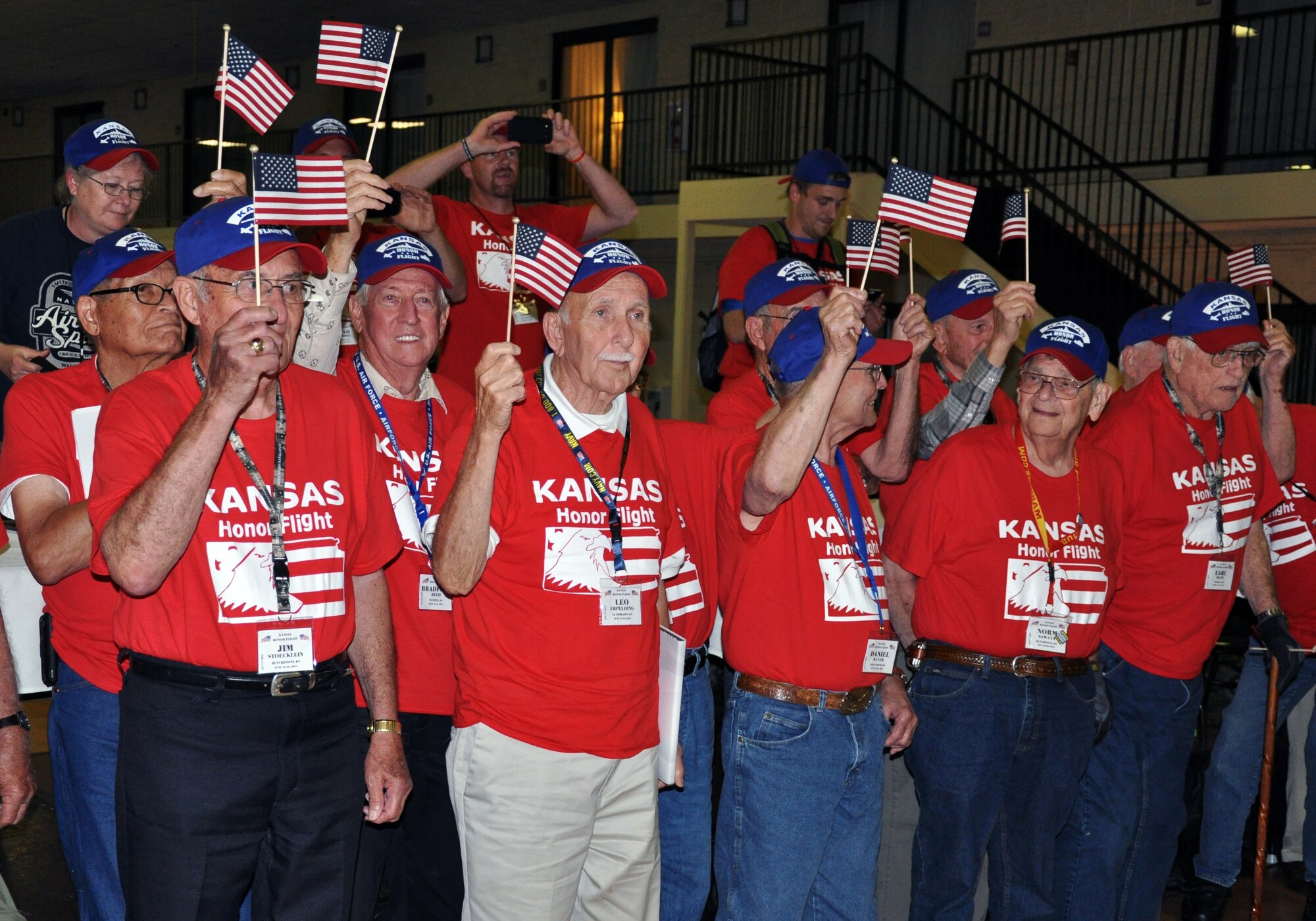 Local World War II and Korean War Veterans take in the applause from the crowd during an Honor Flight welcome home ceremony in Wichita, Kan., June 13, 2014. Family members, community supporters, and more than 40 members of Team McConnell were on hand at the ceremony to greet the Veterans as they returned home from their Honor Flight to Washington, D.C. Honor Flights are conducted by a non-profit organization, and take Veterans to see their war memorials and other sites in the U.S. Capitol. (U.S. Air Force photo by Capt. Zach Anderson)