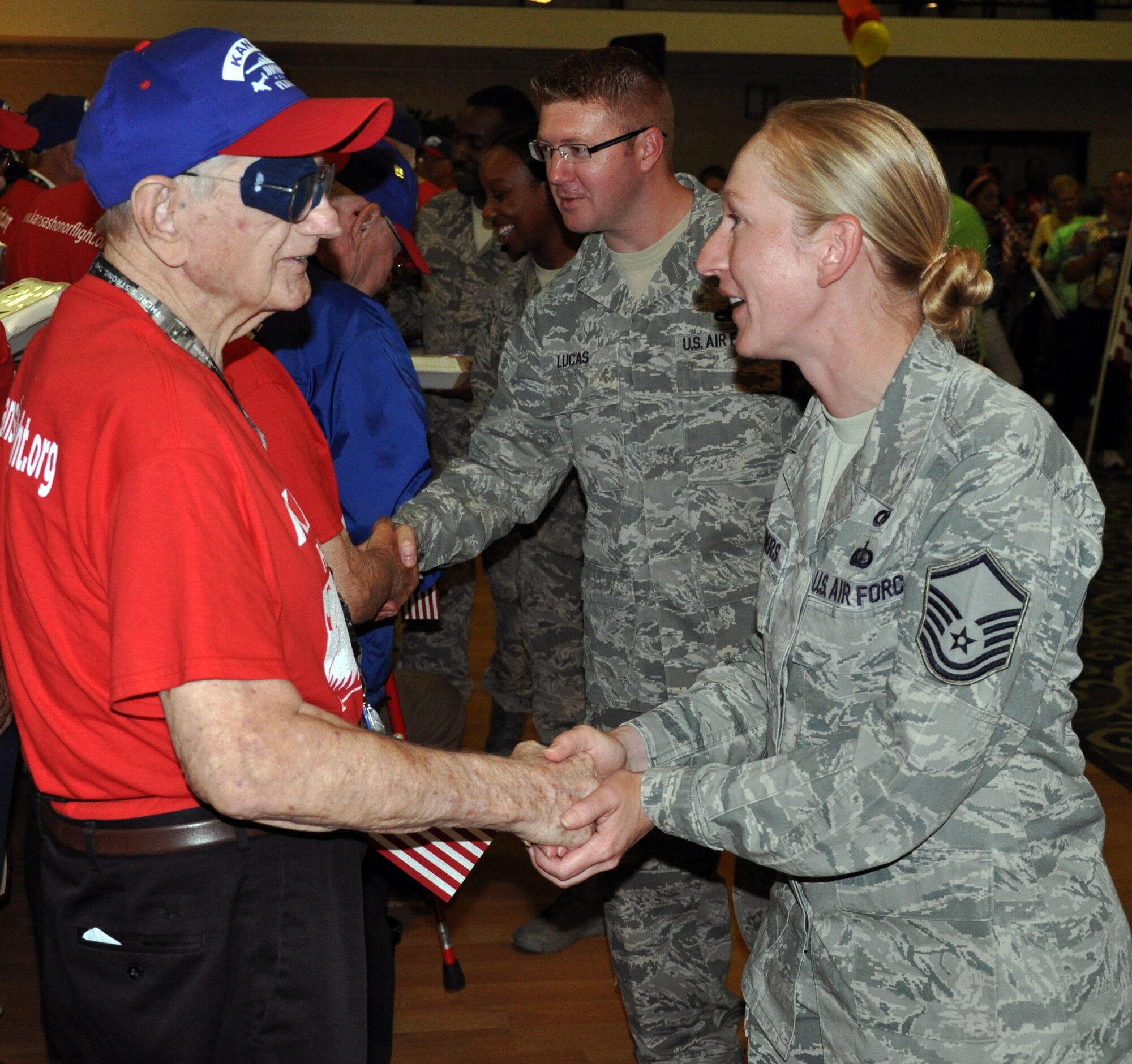 Master Sgt. Felicia Sanders, 931st Air Refueling Group, shakes the hand of a local Korean War Veteran and thanks him for his service during an Honor Flight welcome home ceremony in Wichita, Kan., June 13, 2014. Sanders was one of more than 40 members of Team McConnell on hand to greet 21 World War II and Korean War Veterans as they returned from an Honor Flight to Washington, D.C. Honor Flights are conducted by a non-profit organization, and take Veterans to see their war memorials and other sites in the U.S. Capitol. (U.S. Air Force photo by Capt. Zach Anderson)