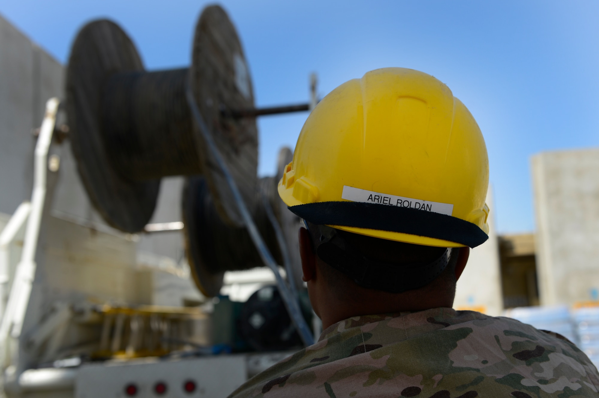Senior Airman Ariel Roldan, Combined Air and Space Operations Center Engineering and Installations cable and antenna technician, pulls cables at Bagram Airfield, Afghanistan, May 15, 2014. The cable is being used at the Air Traffic Control Tower and Command Post to provide connections for several necessary communication supports needed throughout the base. Roldan, a Worcester, Mass. native is deployed from the 212th Engineering and Installation Squadron, Otis Air National Guard Base, Mass. (U.S. Air Force photo by Senior Airman Sandra Welch)
