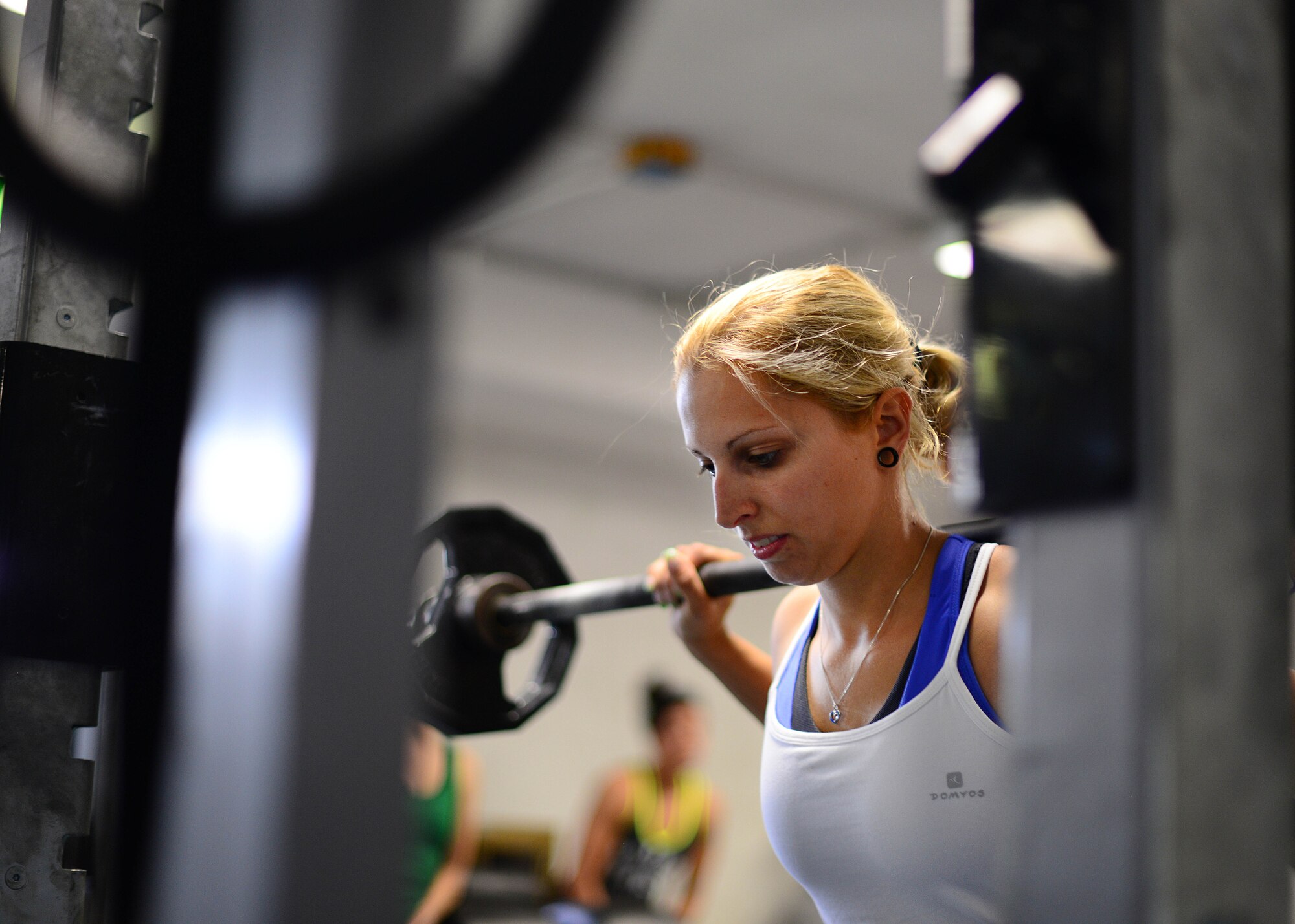 Elisa Hubbard, competitive weightlifter, performs a squat during a weight lifting competition, June 13, 2014, at Aviano Air Base, Italy. Participants competed in squats, bench press and dead lifts for the title of Team Aviano’s strongest member. (U.S. Air Force photo/Airman 1st Class Ryan Conroy) 